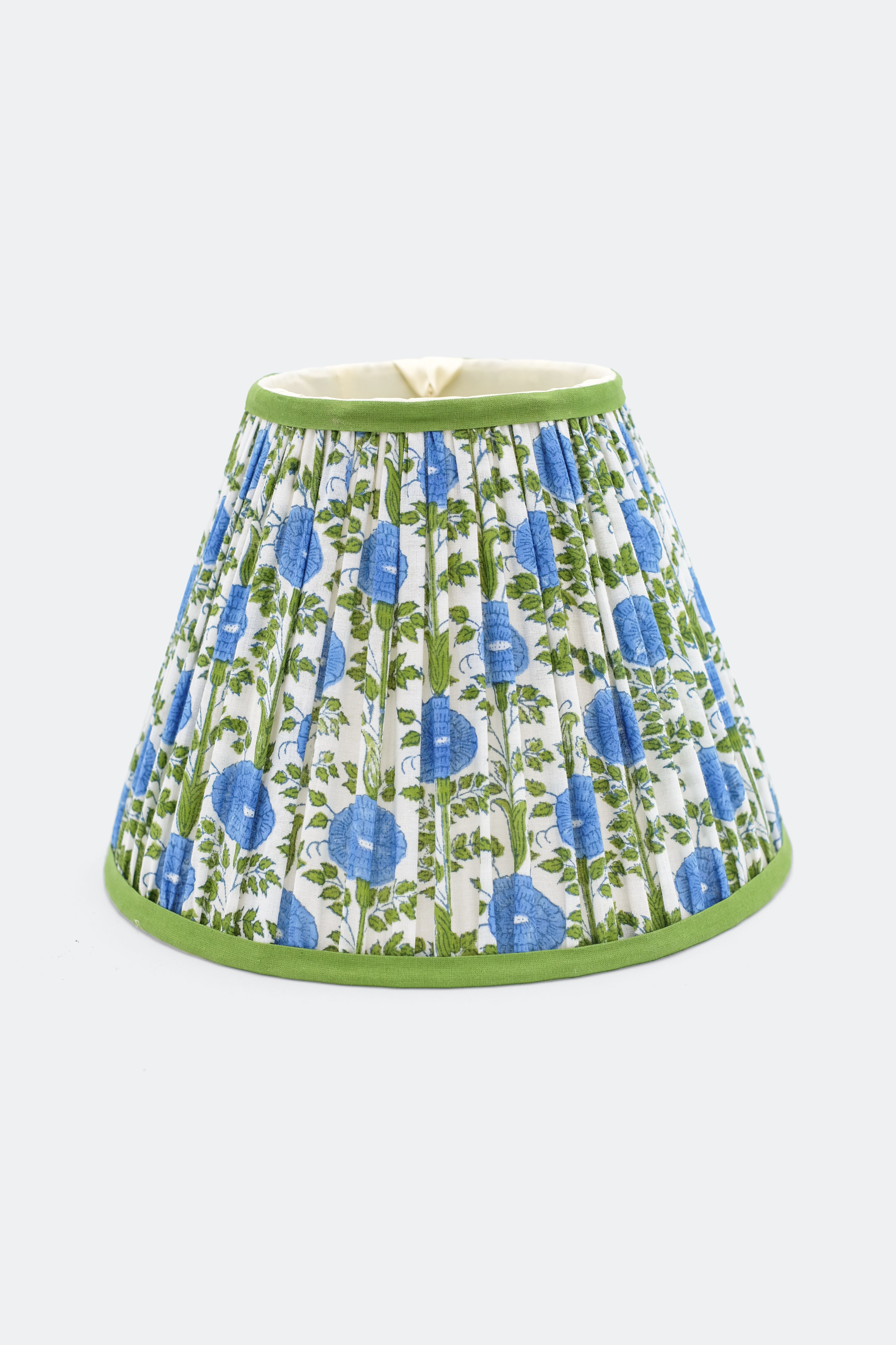 10-inch pleated blockprint empire lampshade in Araminta Blue, featuring blue floral and green leaf patterns on white fabric with green top and bottom trim.