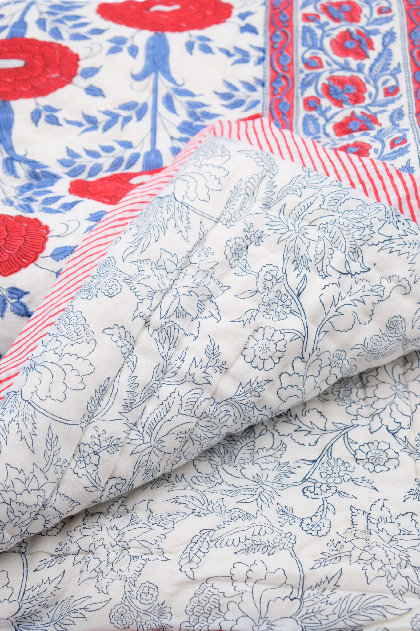 Blue and white reversible quilt with floral designs