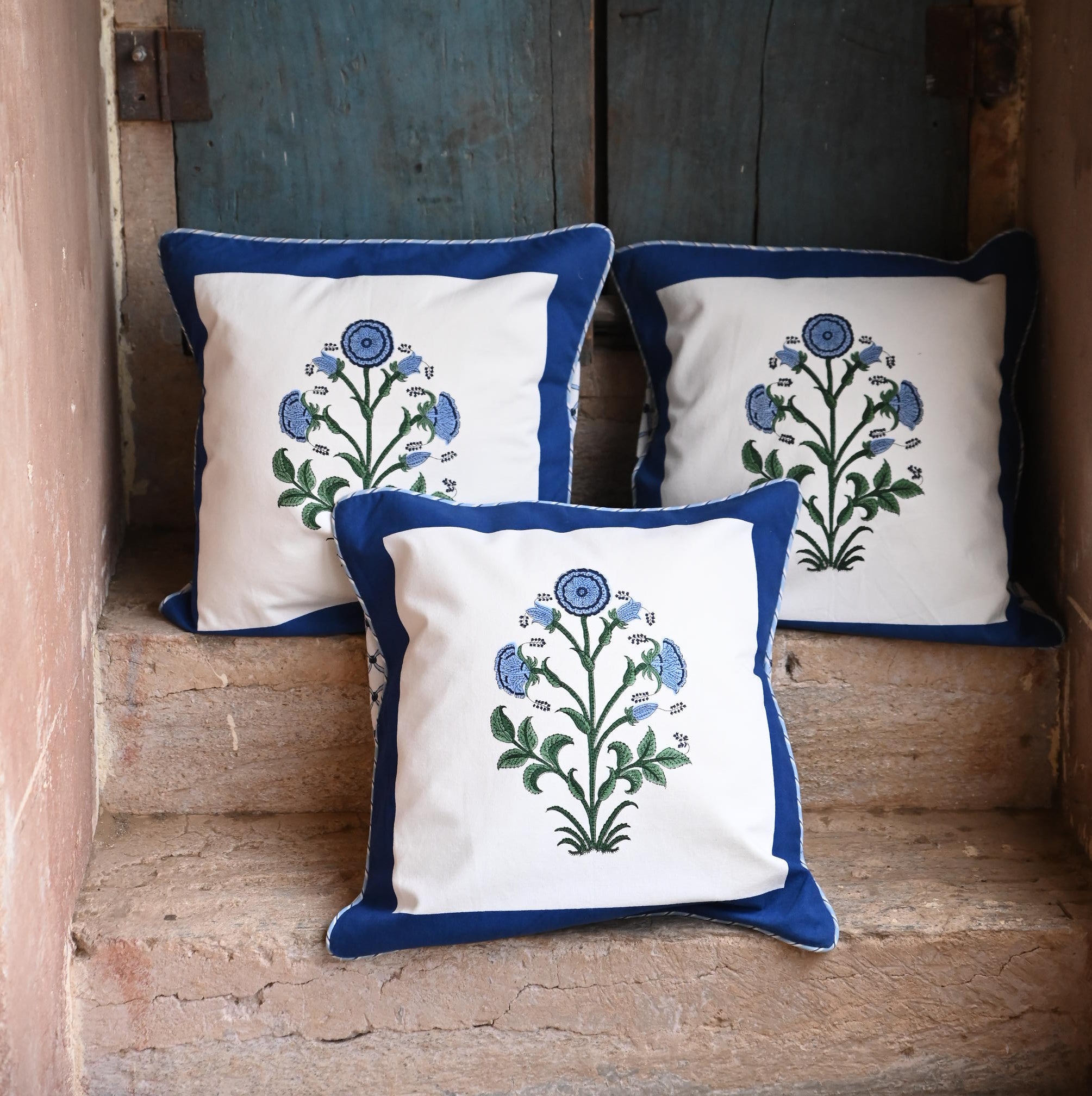 Cobalt botanical blockprint pillows near vintage door