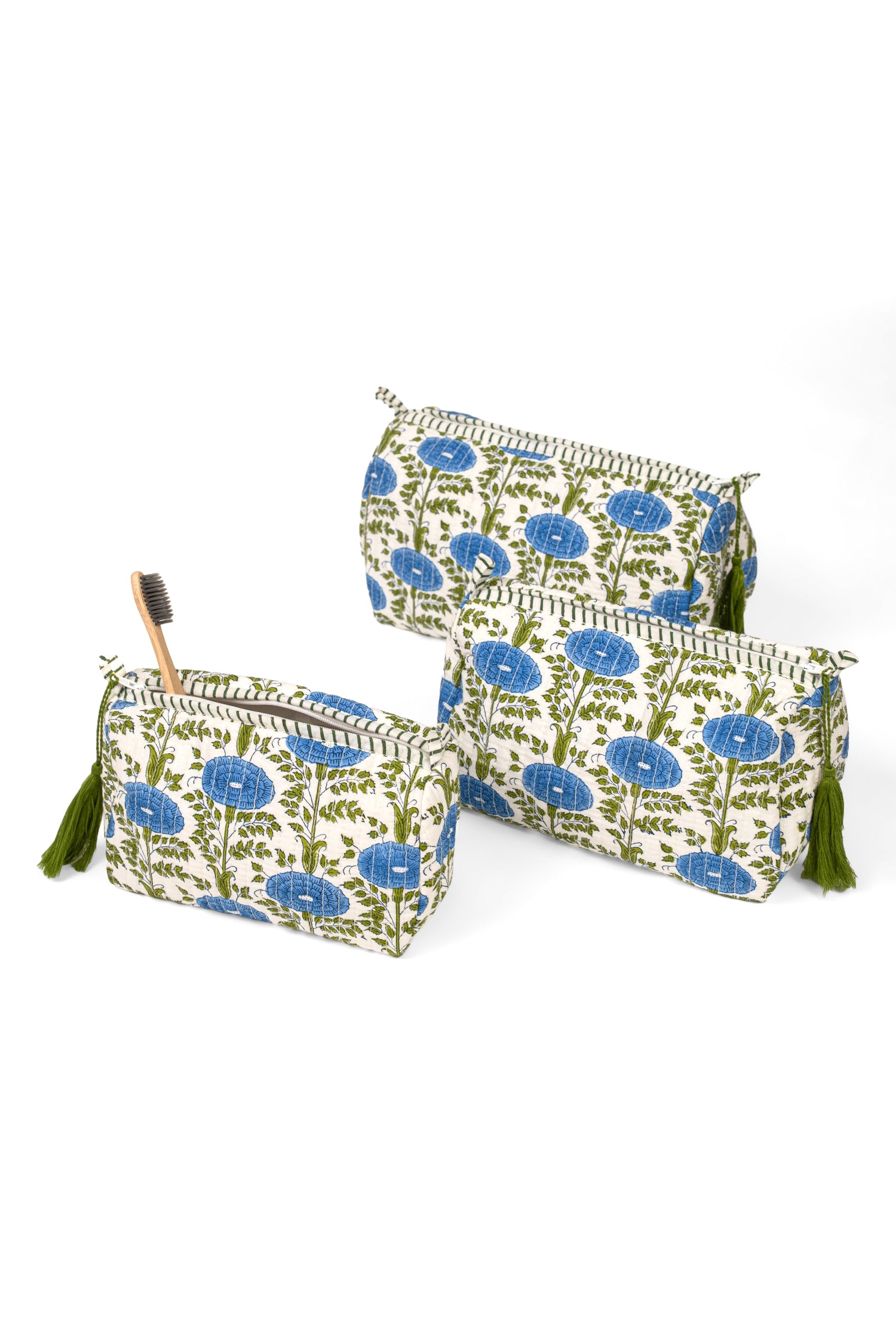 Three blue toiletry bags with one open showing contents from Inner Child