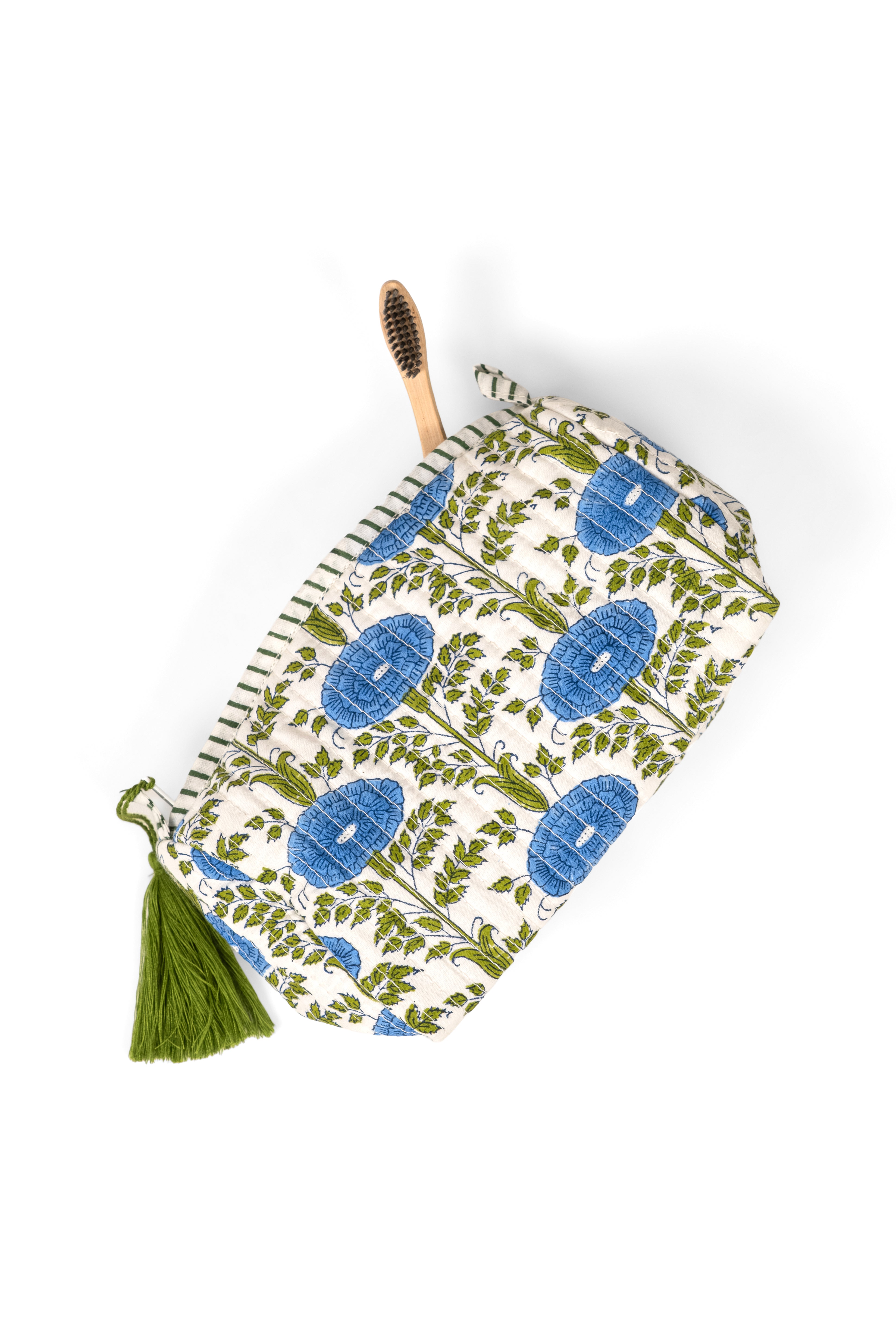 Blue floral toiletry bag with green foliage print, tassel closure