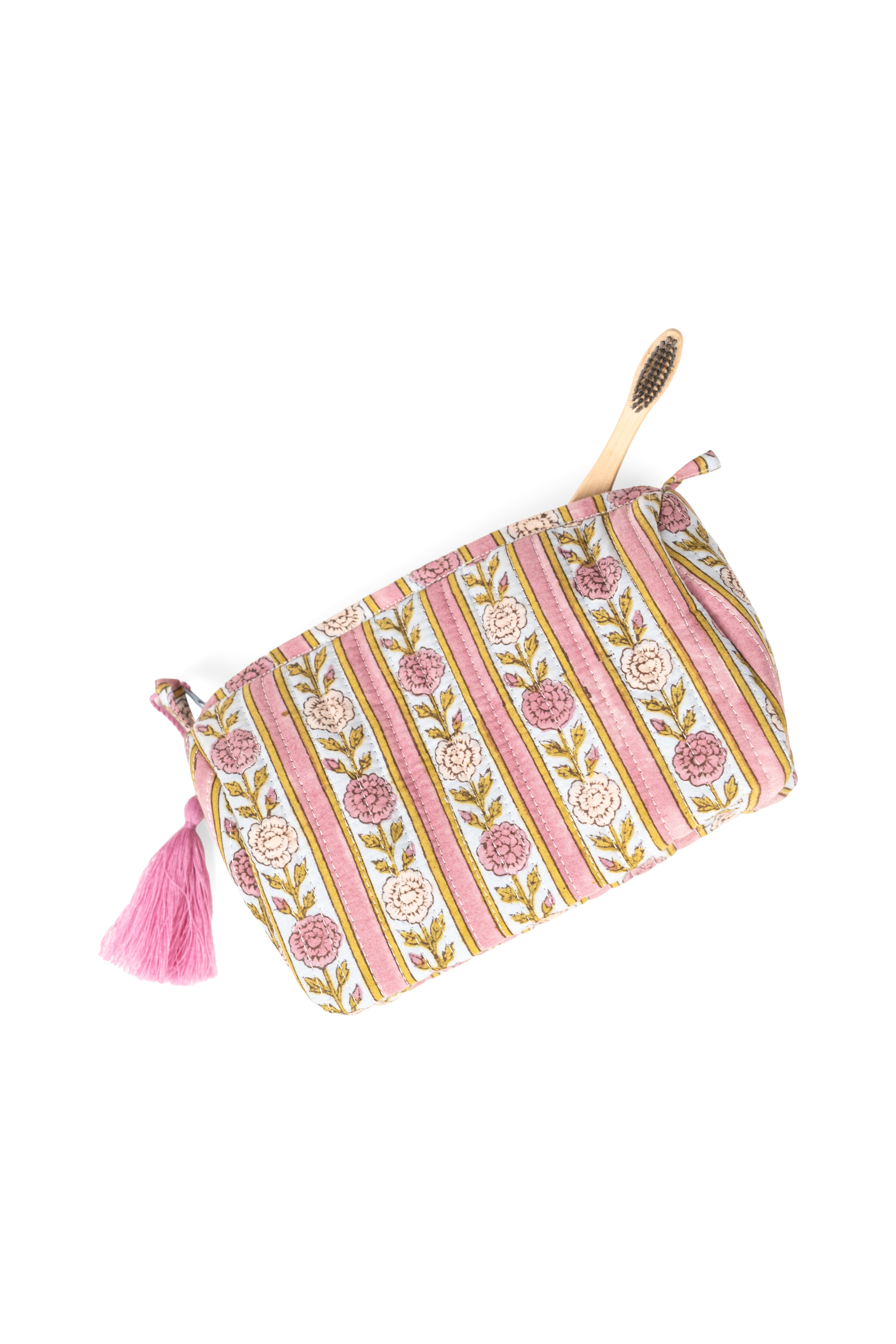 Single vintage floral striped makeup bag with pink tassel and wooden brush peeking out