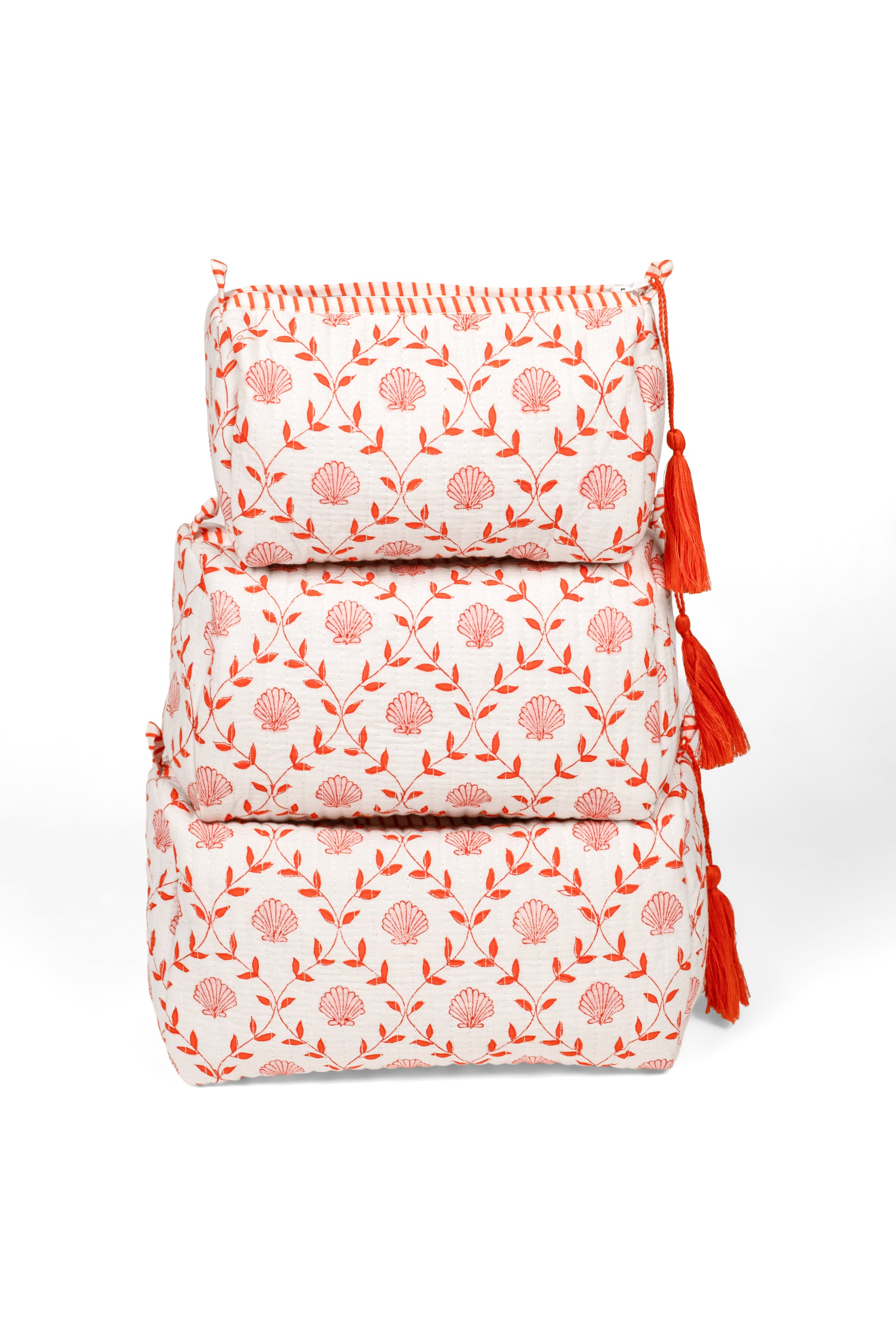 Stack of 3 pink seashell blockprint makeup bags with tassels
