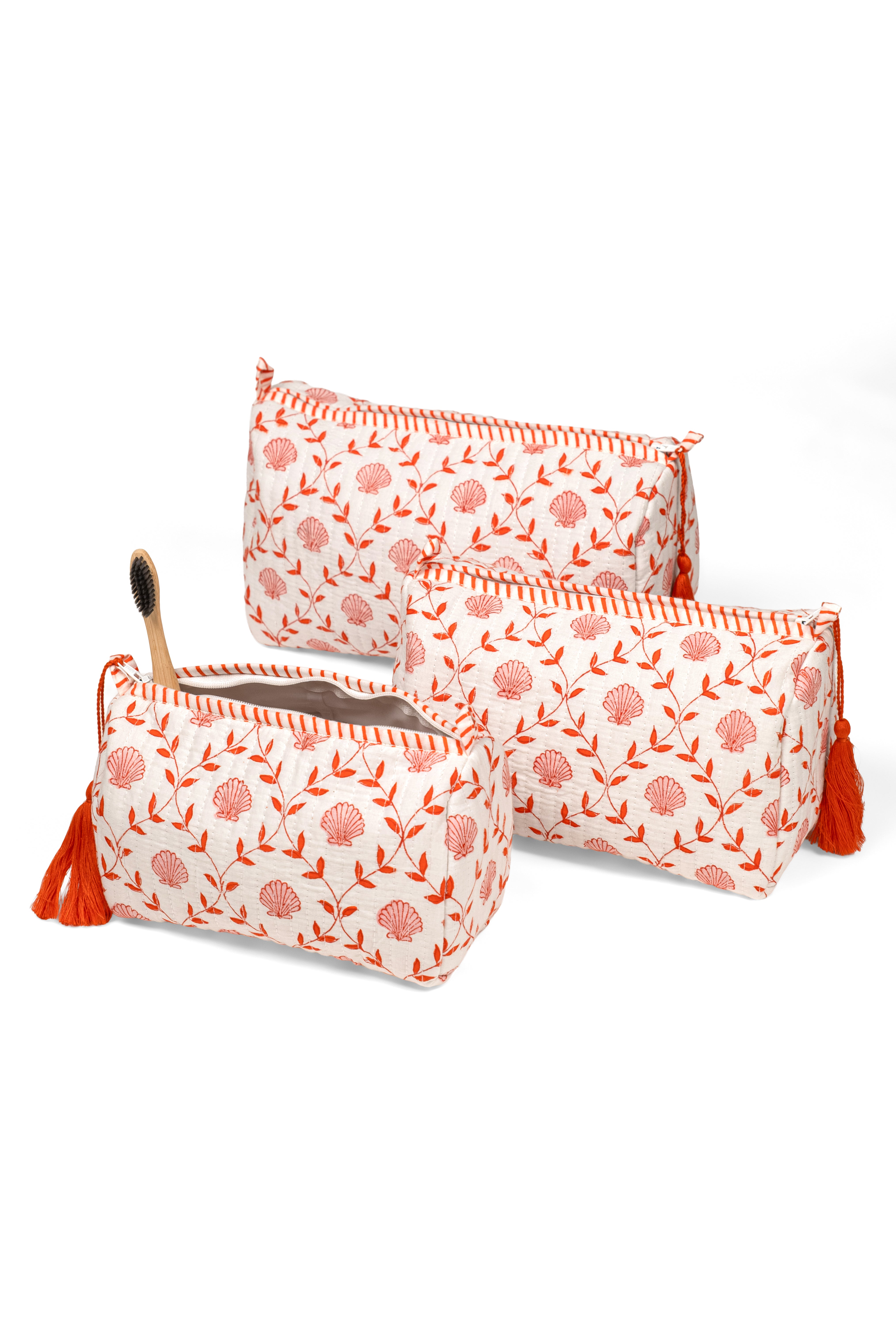 Multi-sized pink seashell blockprint makeup bags with tassels from Inner Child