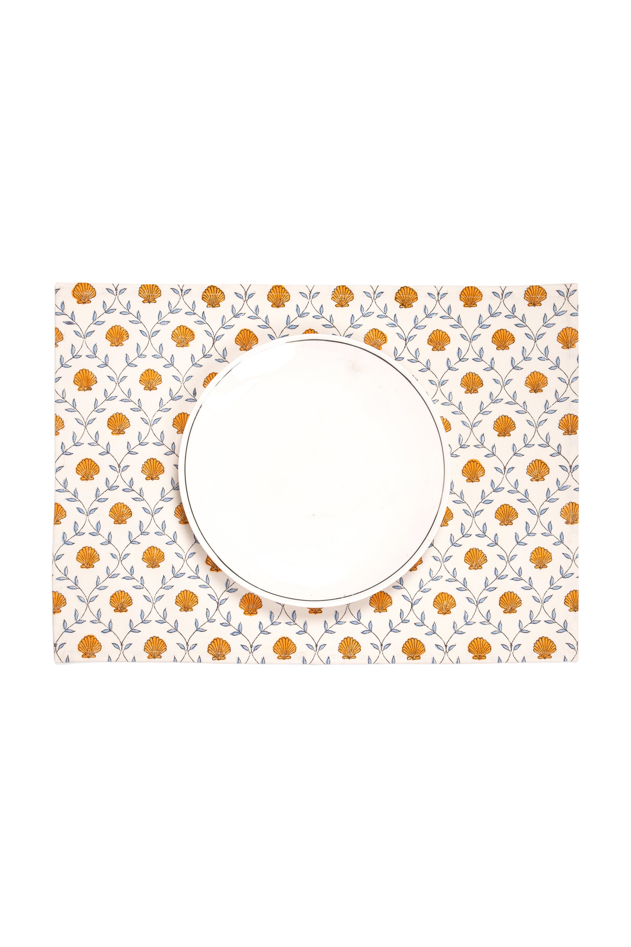 Orange shell blockprint placemat with white plate from Inner Child