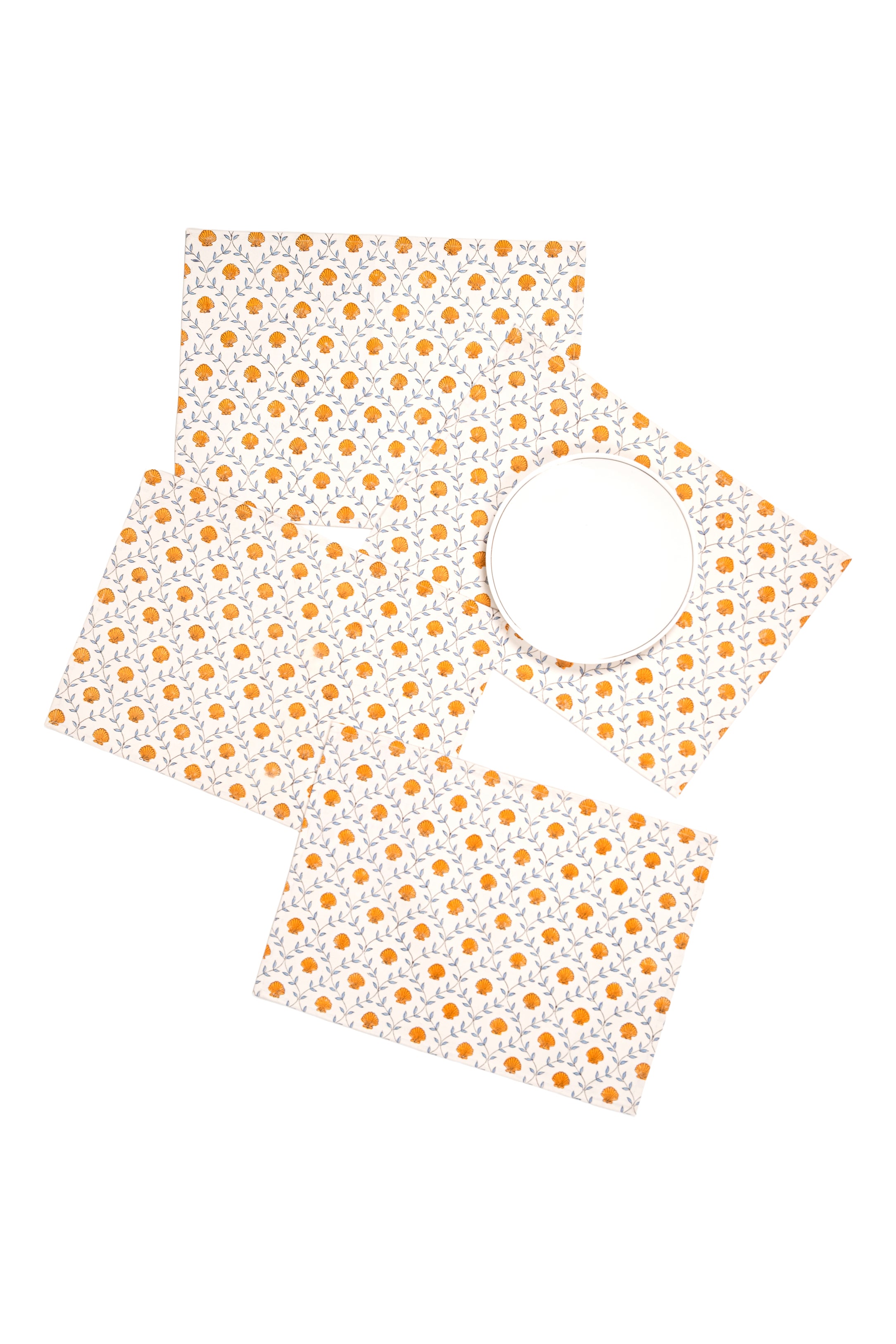 Orange blockprint seashell placemats with blue vine pattern from Inner Child