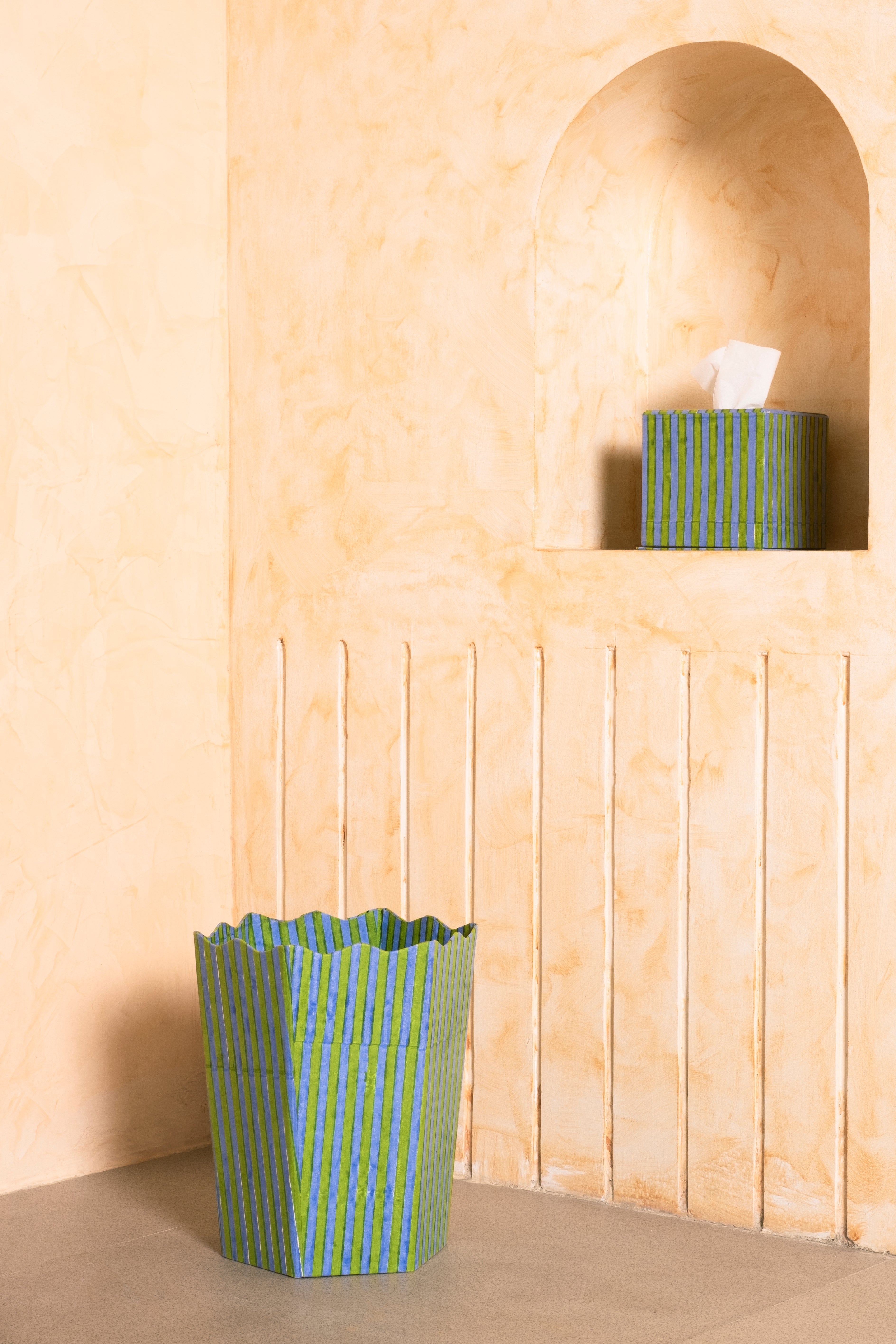Green and blue striped blockprint tissue box set displayed against warm-toned wall