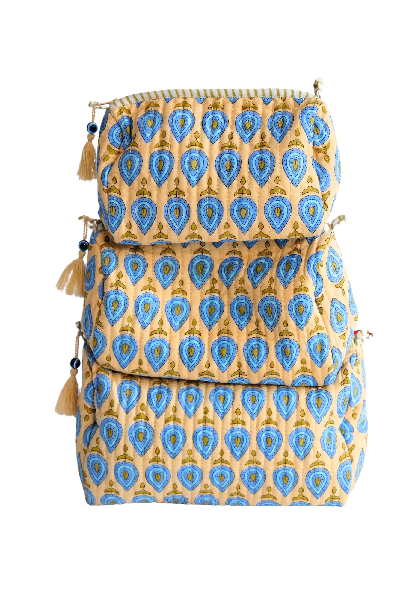 Stacked evil eye charm toiletry bags with blue teardrop patterns, tassels, zipper detail