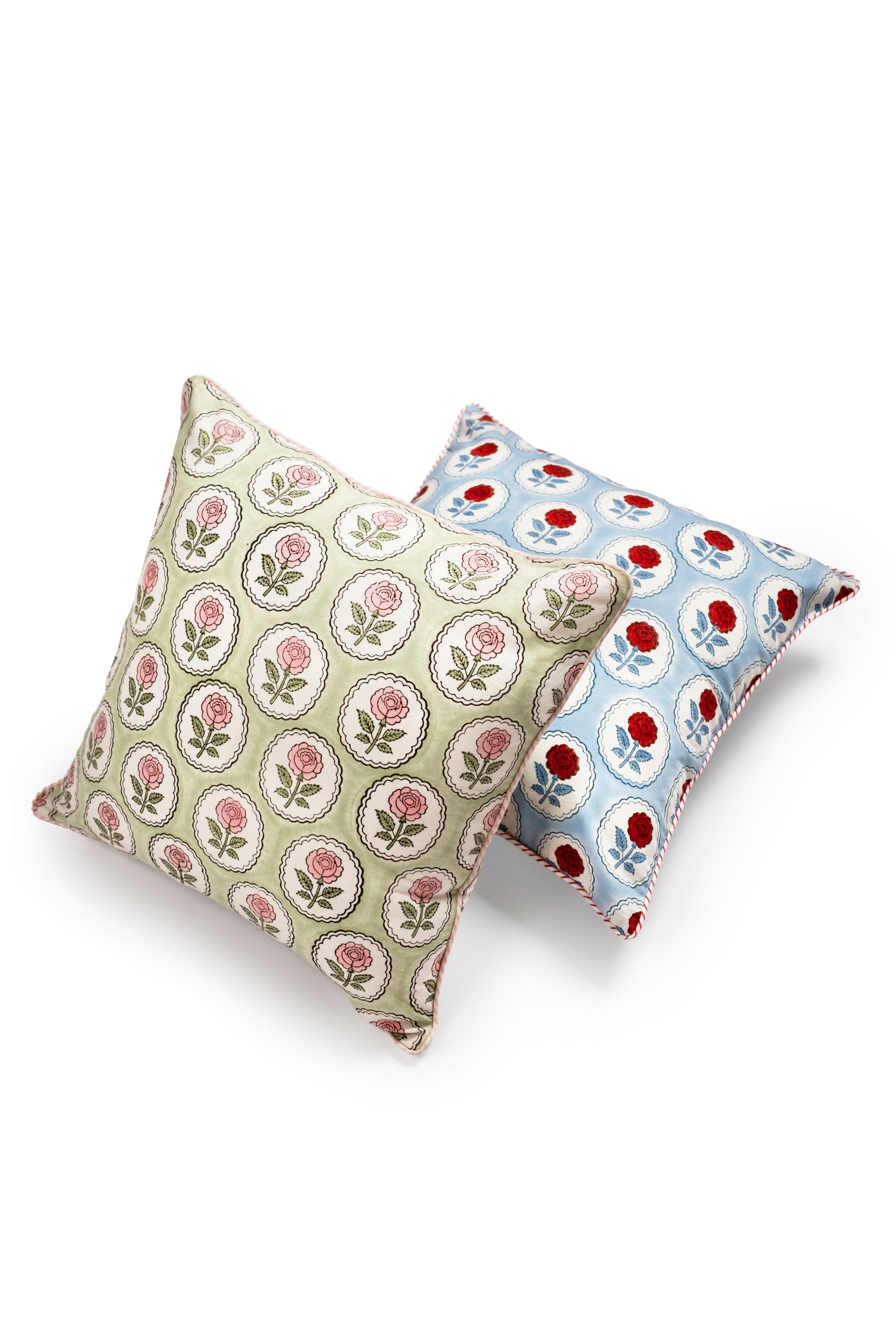 Pink and green English rose blockprint pillow cover alongside blue-red version by Inner Child
