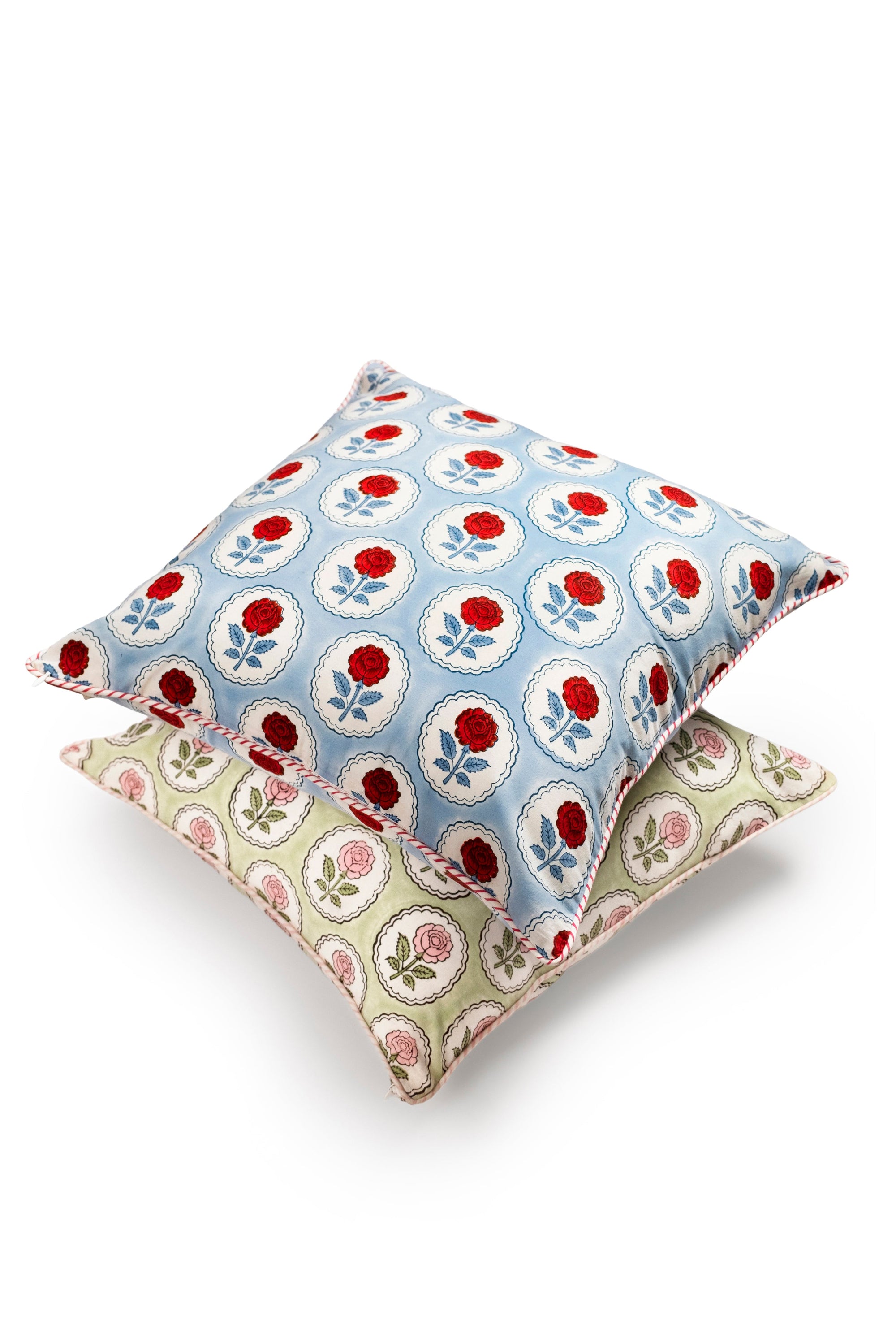 Pink and green English rose blockprint pillow cover with blue-red counterpart stacked below by Inner Child