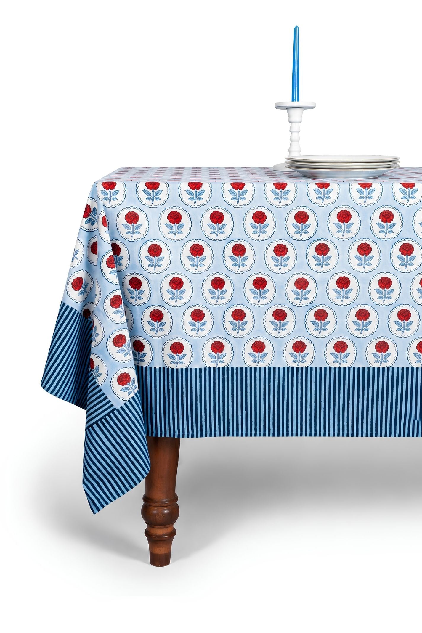 Inner Child red rose blockprint tablecloth on wooden table with blue striped border