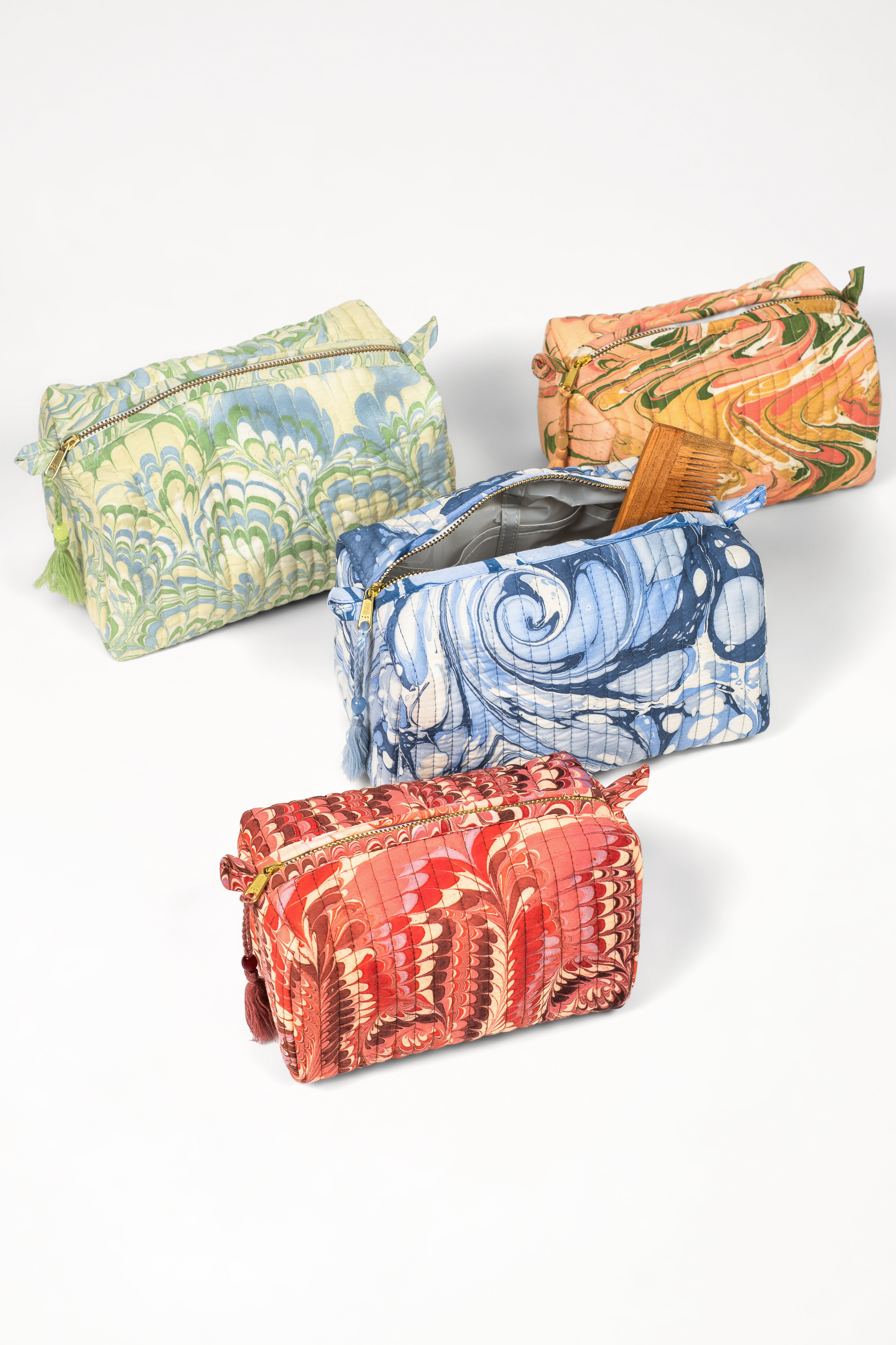 Collection of peony bloom hand-marbled cosmetic bags in assorted patterns