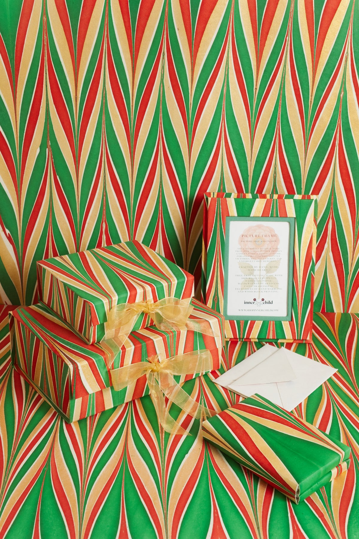 Gilded Holiday hand-marbled 4x6 frame with wrapped gifts on red, green and gold chevron marbled paper