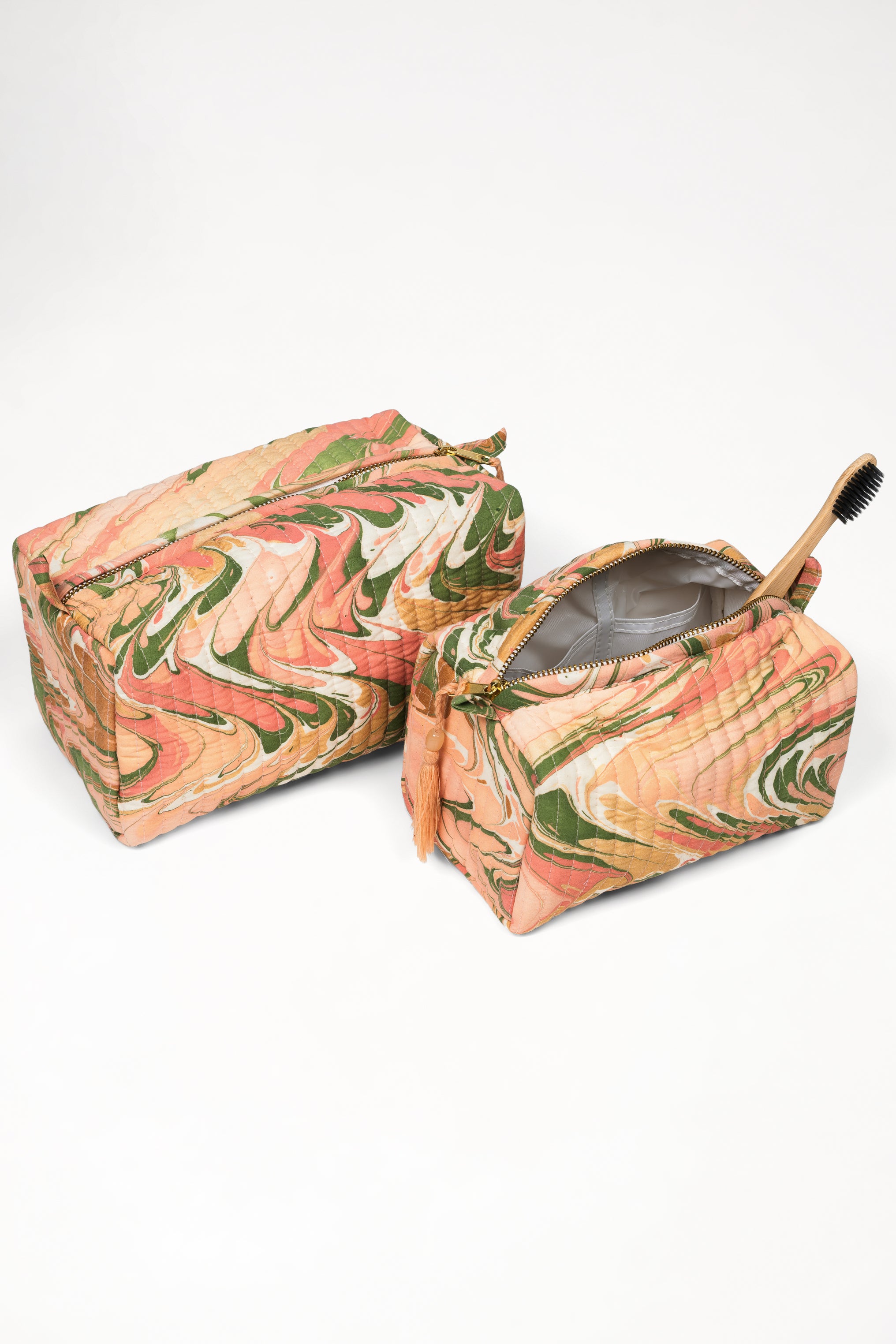 Peony bloom hand-marbled cosmetic bags set; one open with wooden toothbrush