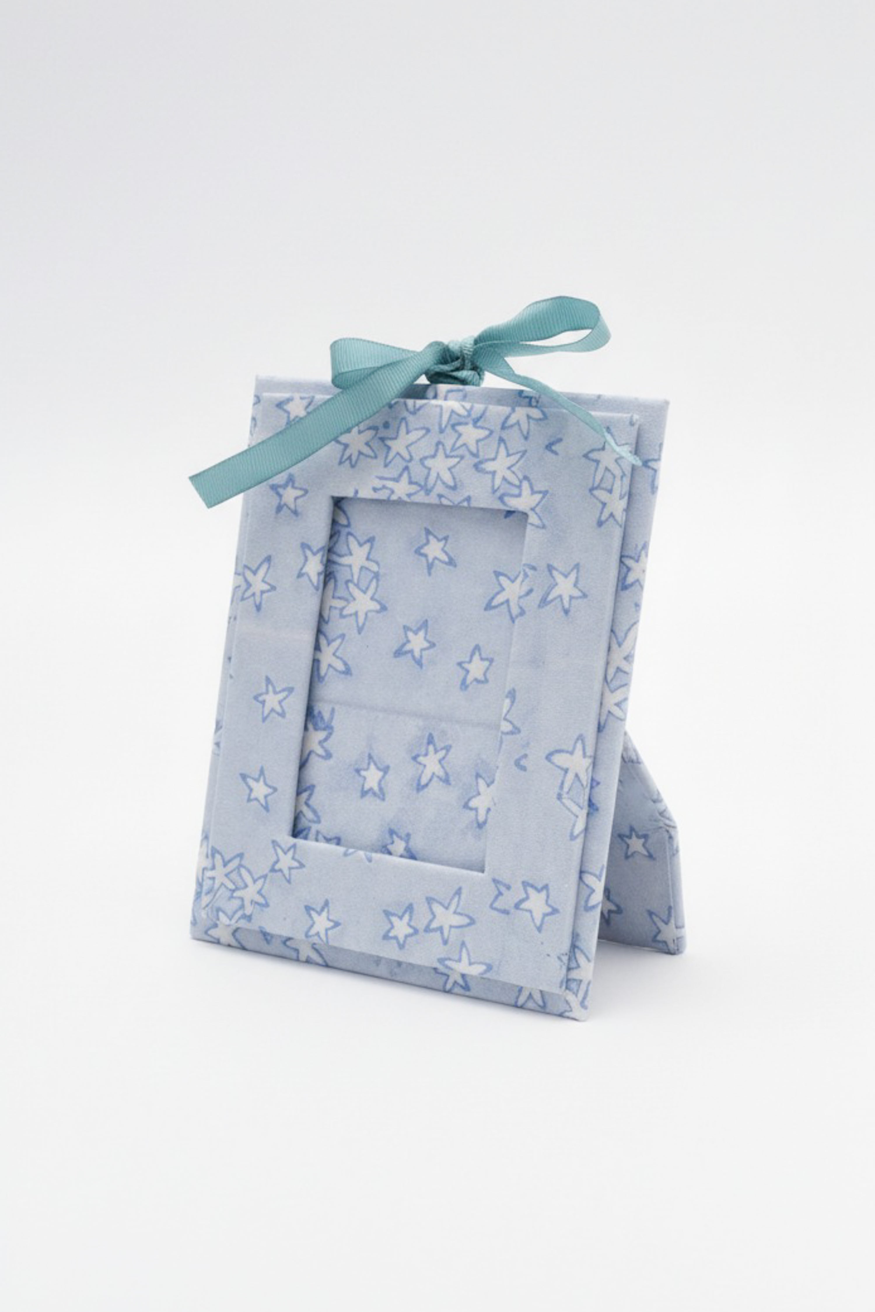 Blue star-patterned mini blockprint picture frame ornament standing upright on white surface