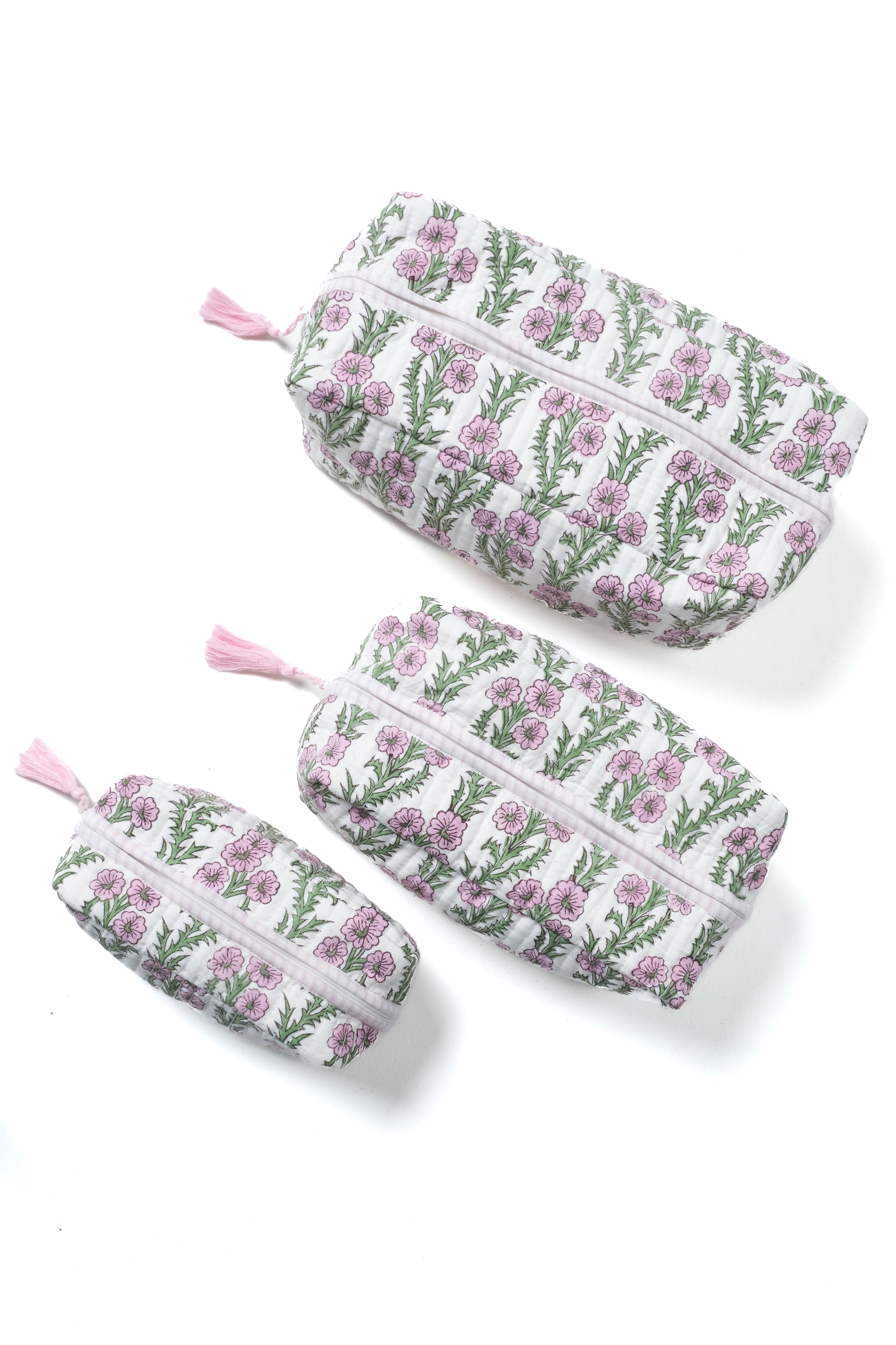 Set of lilac pink blockprint makeup bags with forget-me-not floral pattern, pink tassels