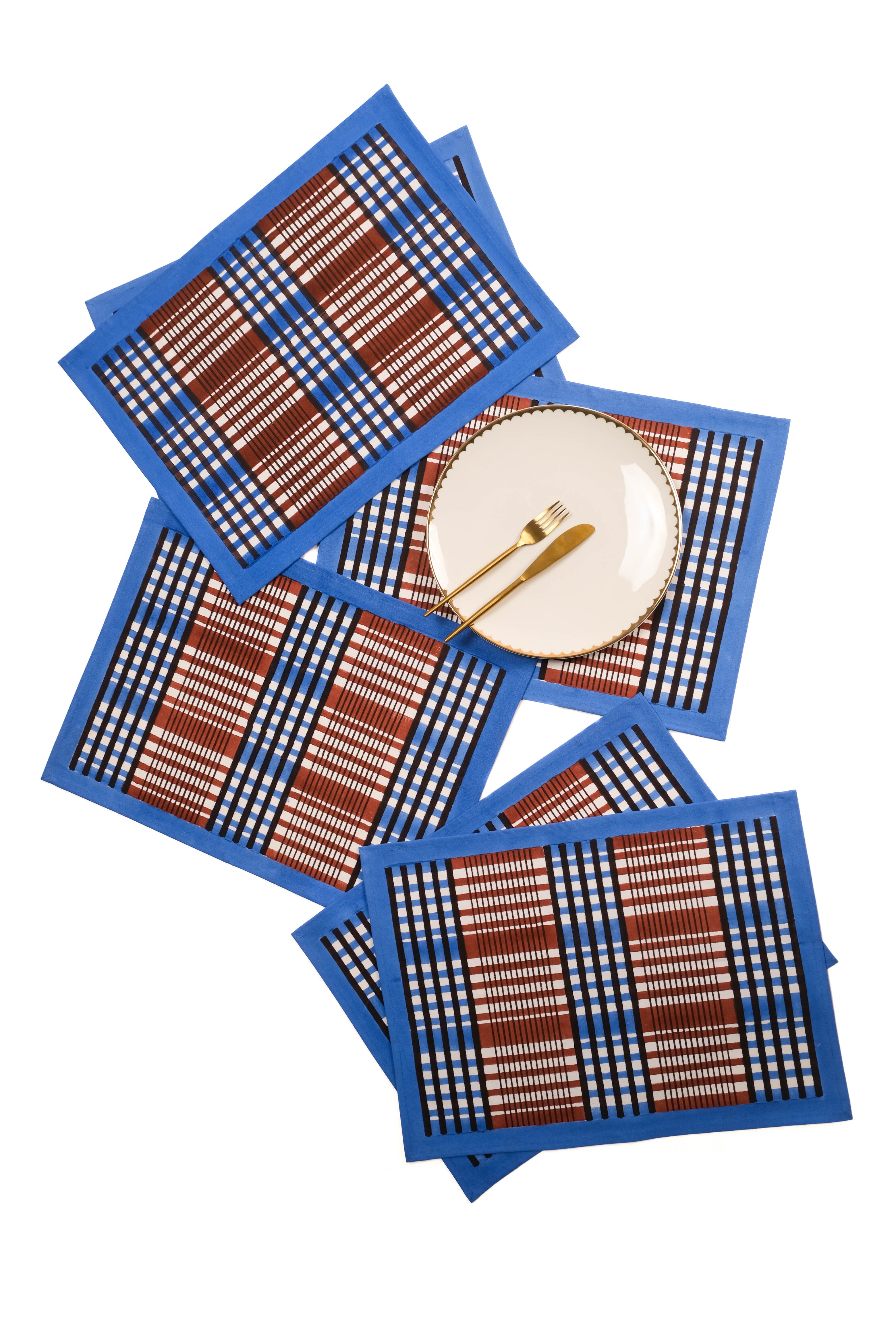 Multiple brown and blue Shetland plaid blockprint placemats with white plate