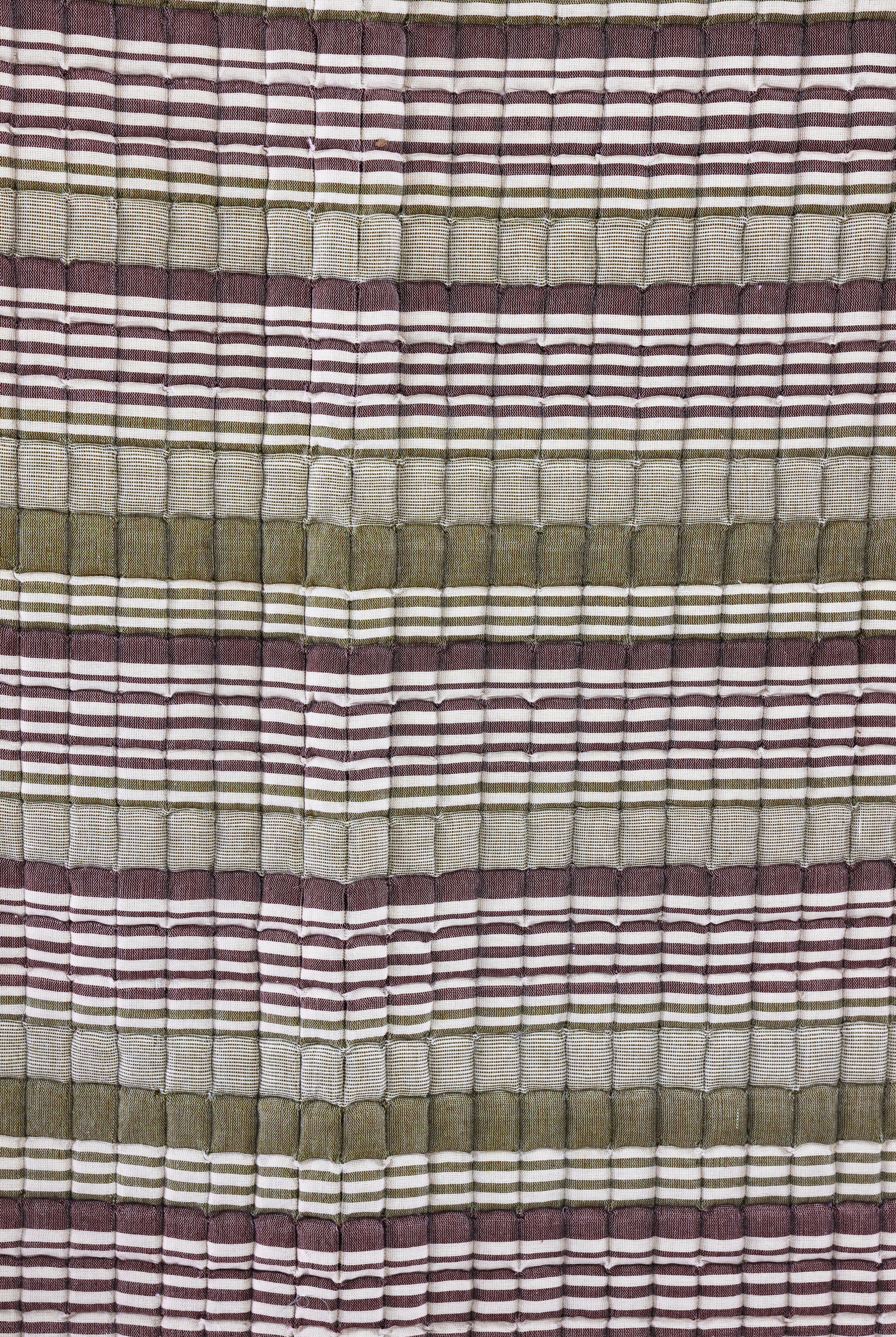 Close-up of sage-dusty rose quilt texture from Inner Child