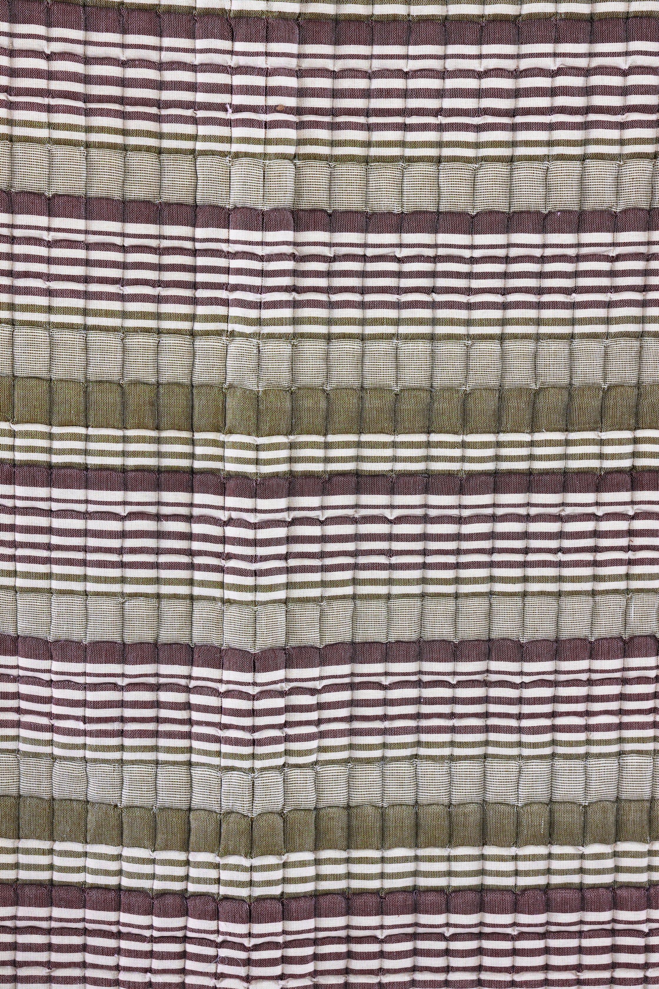 Close-up of sage-dusty rose quilt texture from Inner Child