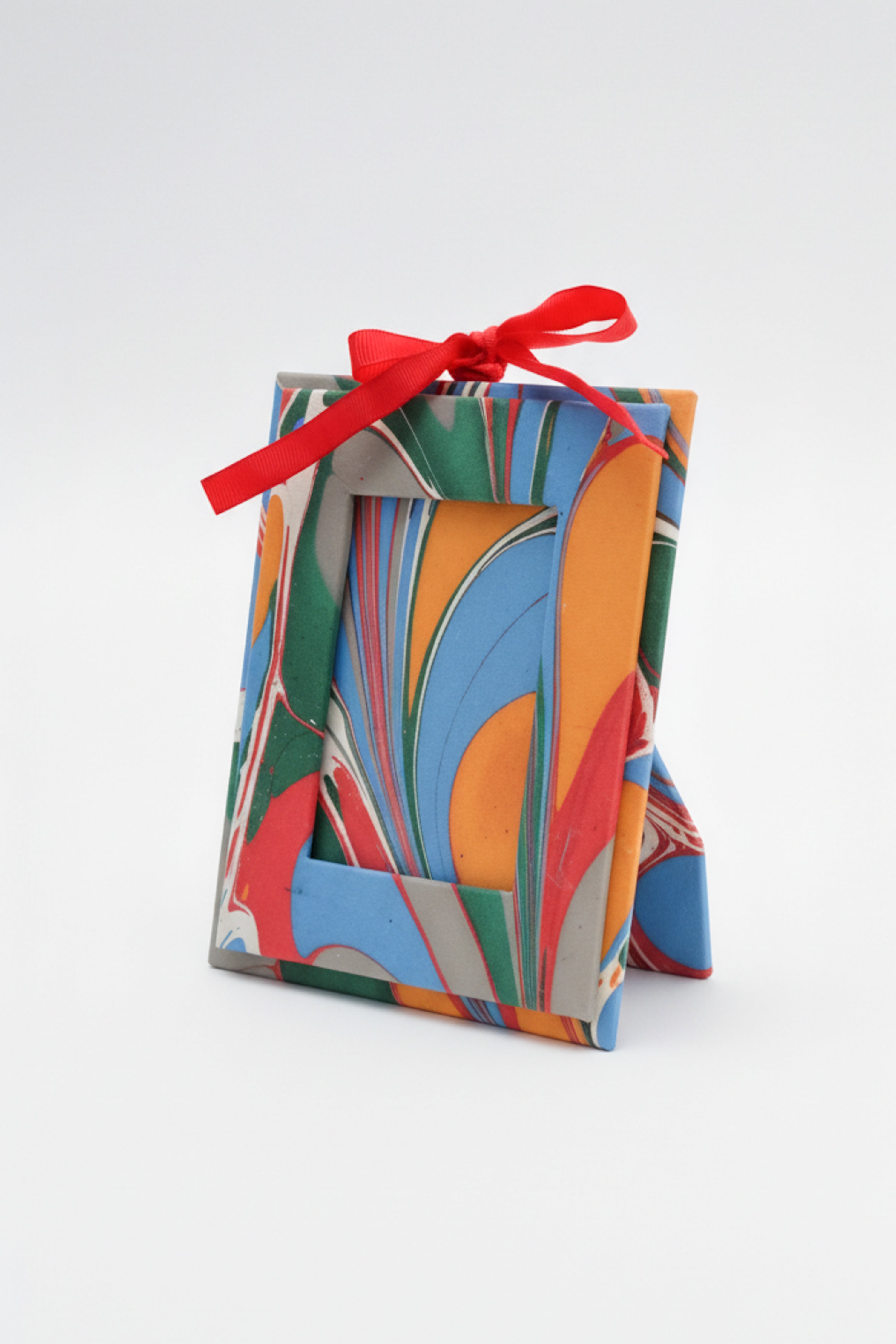 Mini hand-marbled picture frame ornament with vibrant colors and red ribbon - Inner Child