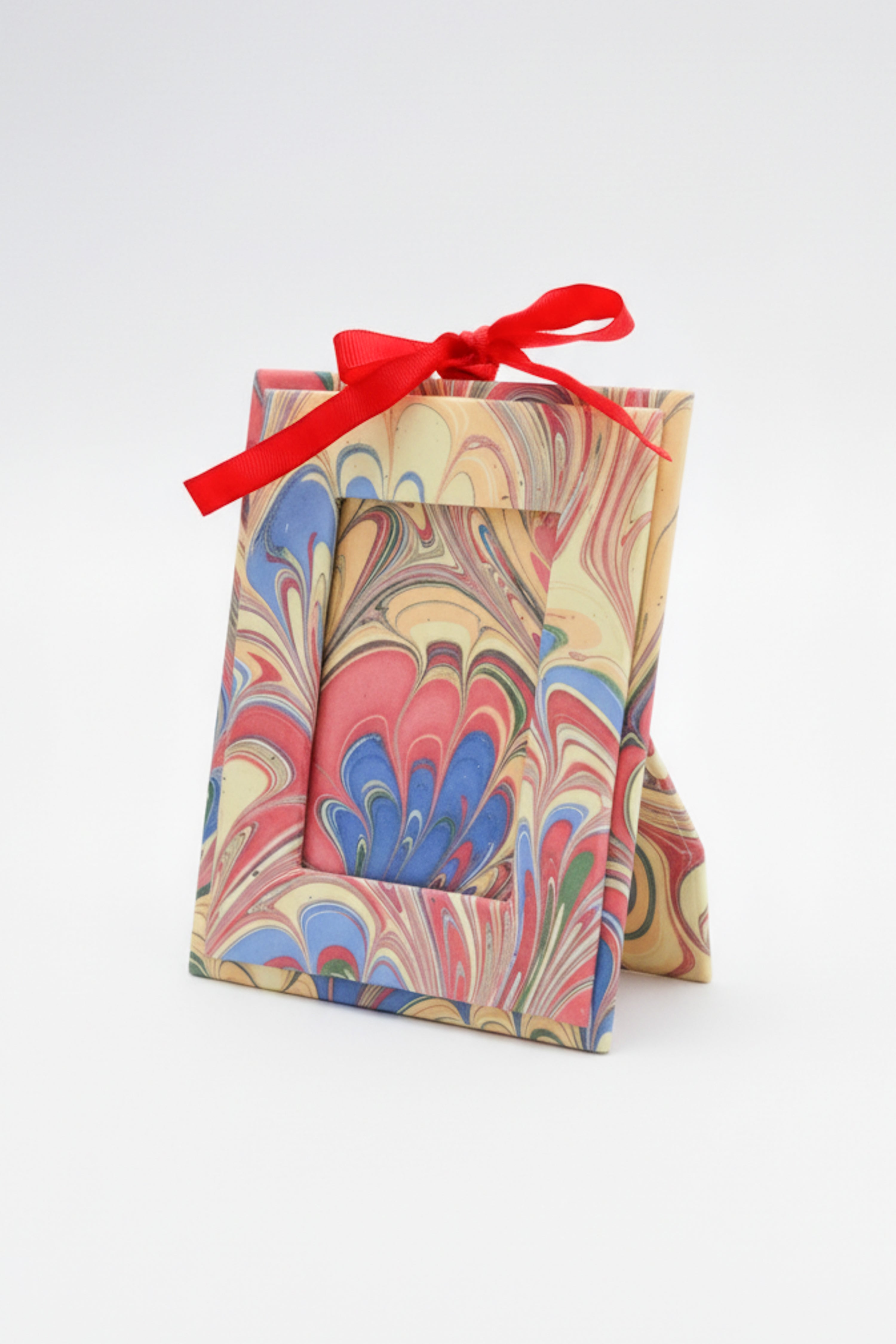 Mini hand-marbled standing picture frame ornament with pink-blue-orange patterns & red ribbon | Inner Child