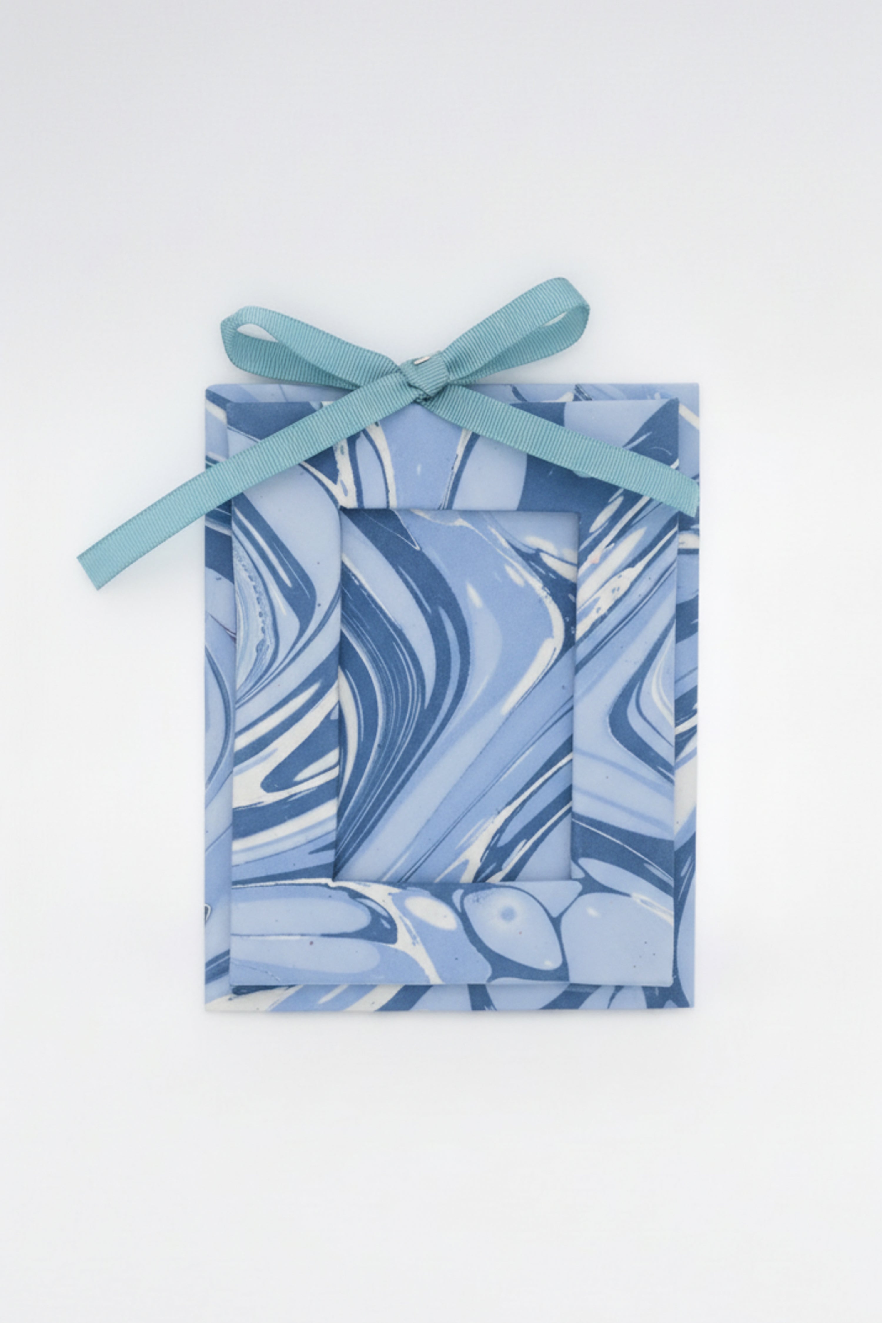 Mini hand-marbled ocean wave picture frame ornament with teal ribbon