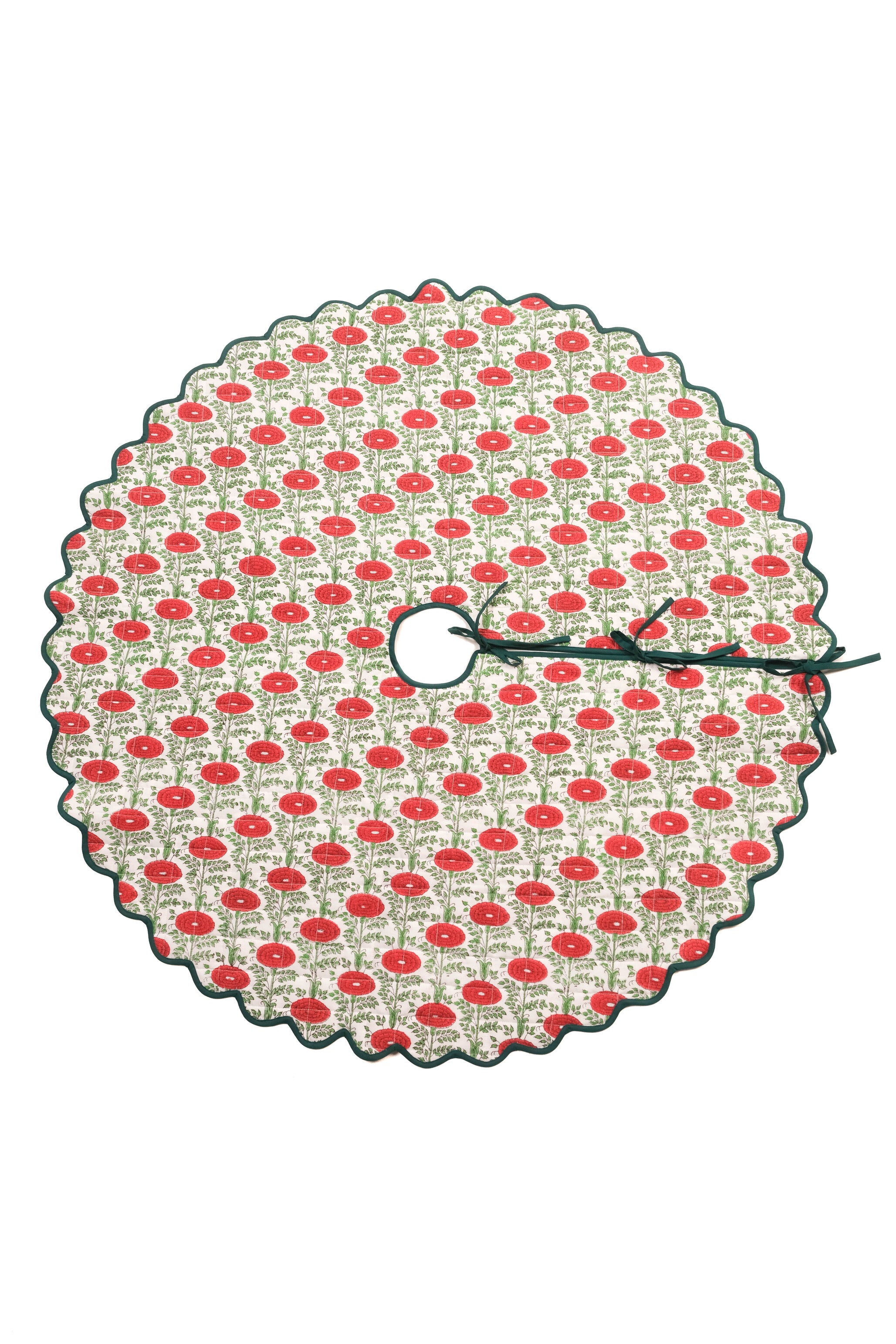 Scallop-edged quilted tree skirt with red blockprint floral patterns