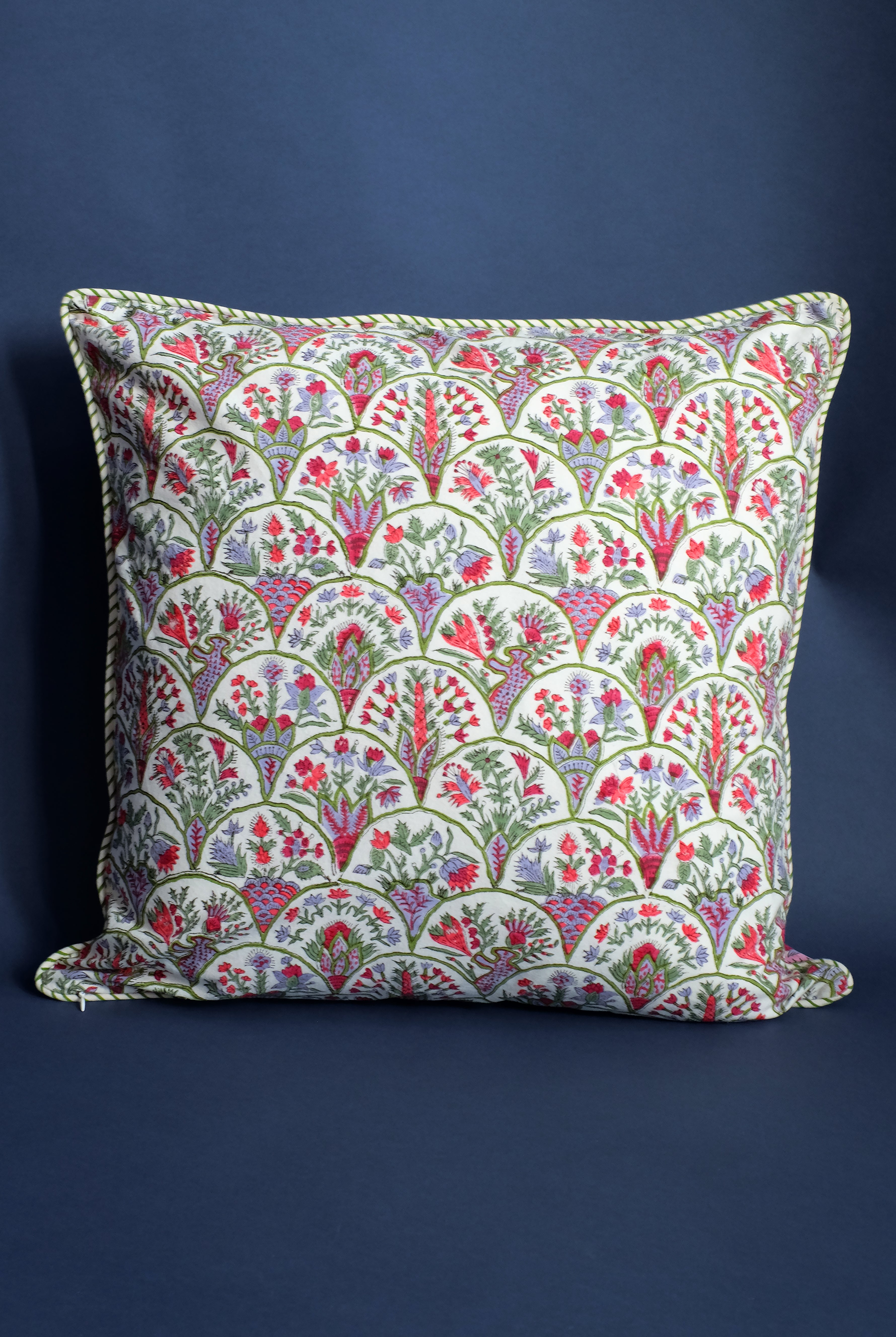 Pink arch blockprint reversible decorative pillow against navy blue backdrop