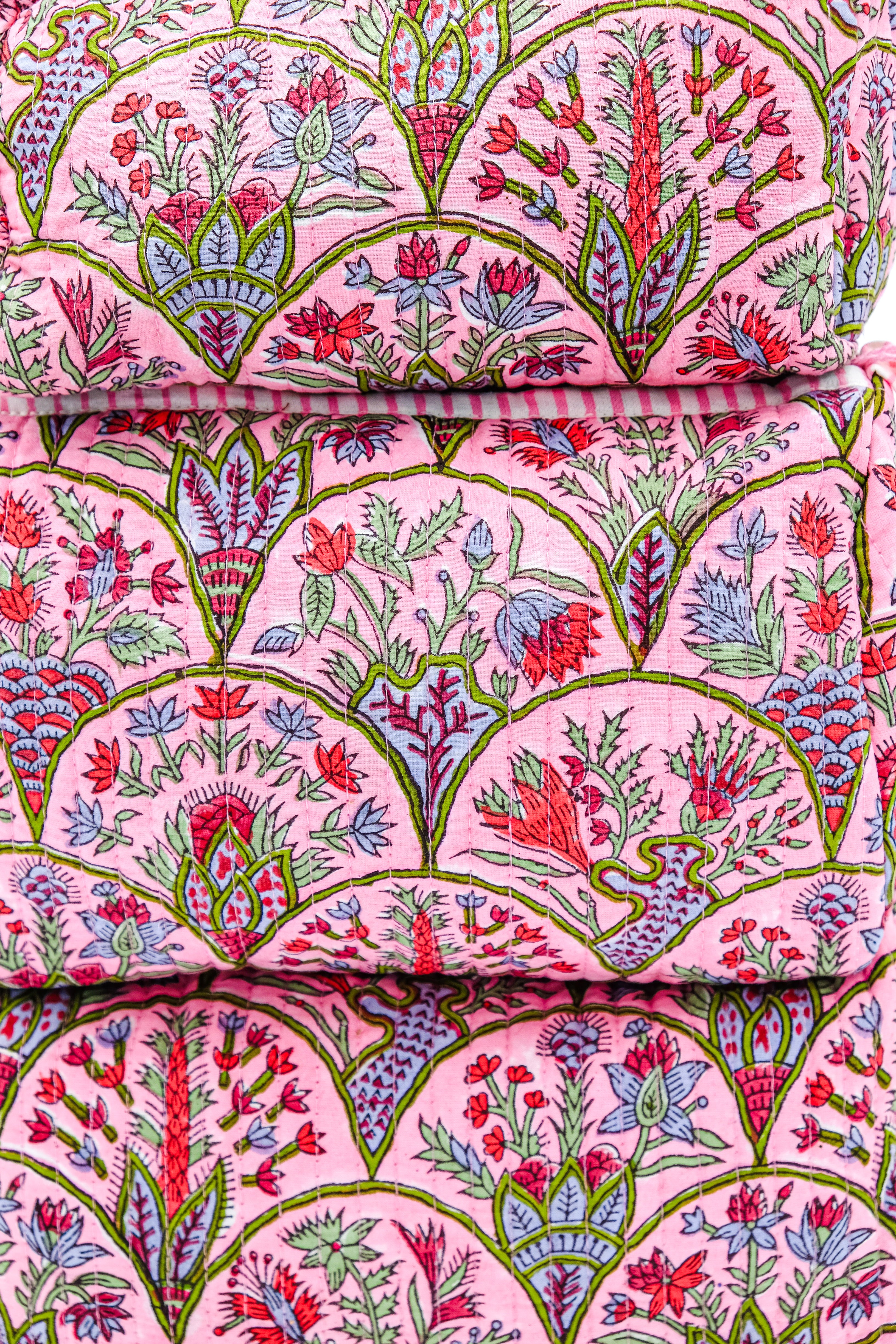 Close-up pink Arch toiletry bag fabric with floral patterns
