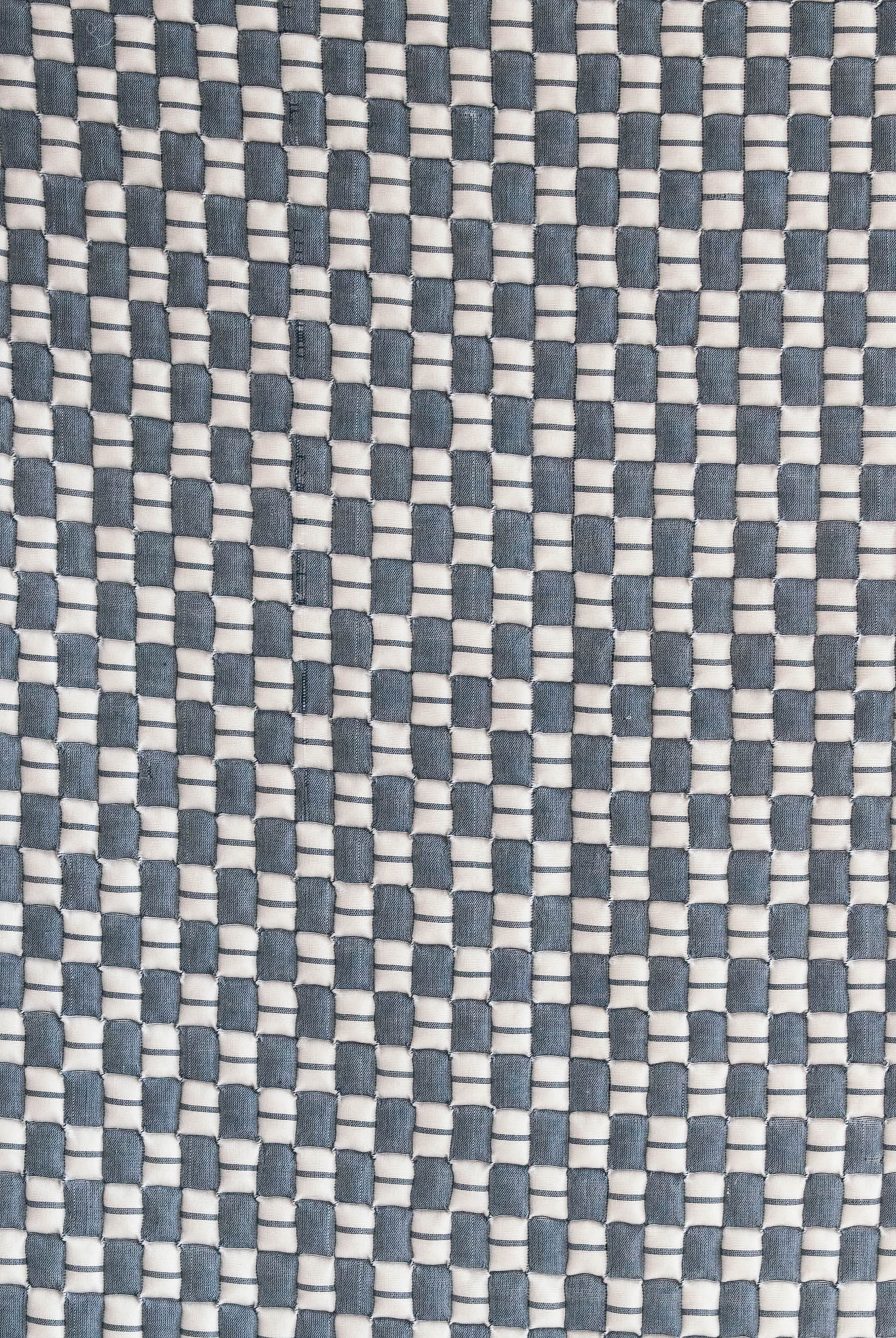 Close-up of blue and white checkered Sujani quilt fabric