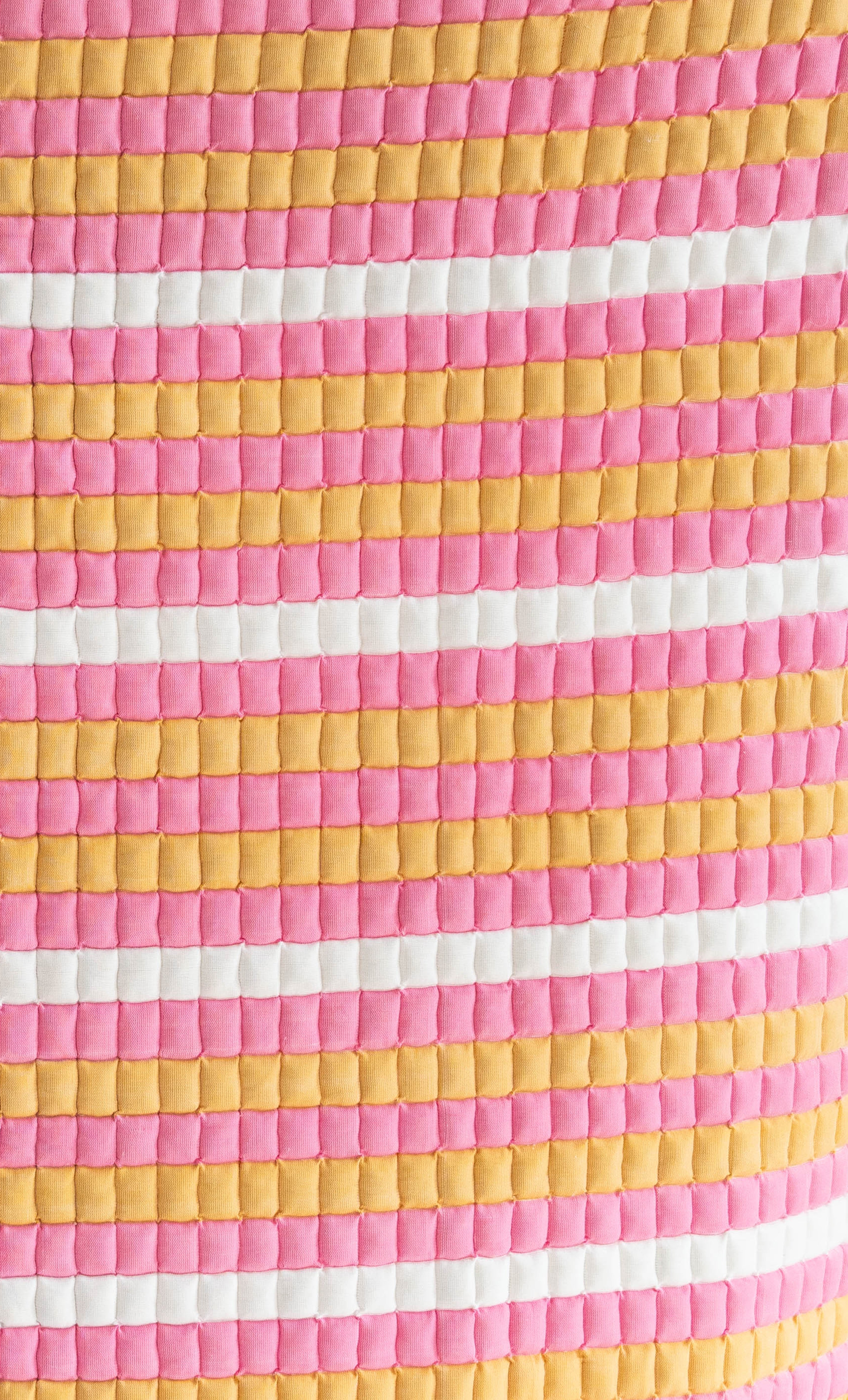 Close-up detail of pink-yellow-white Grand Budapest Sujani quilt fabric