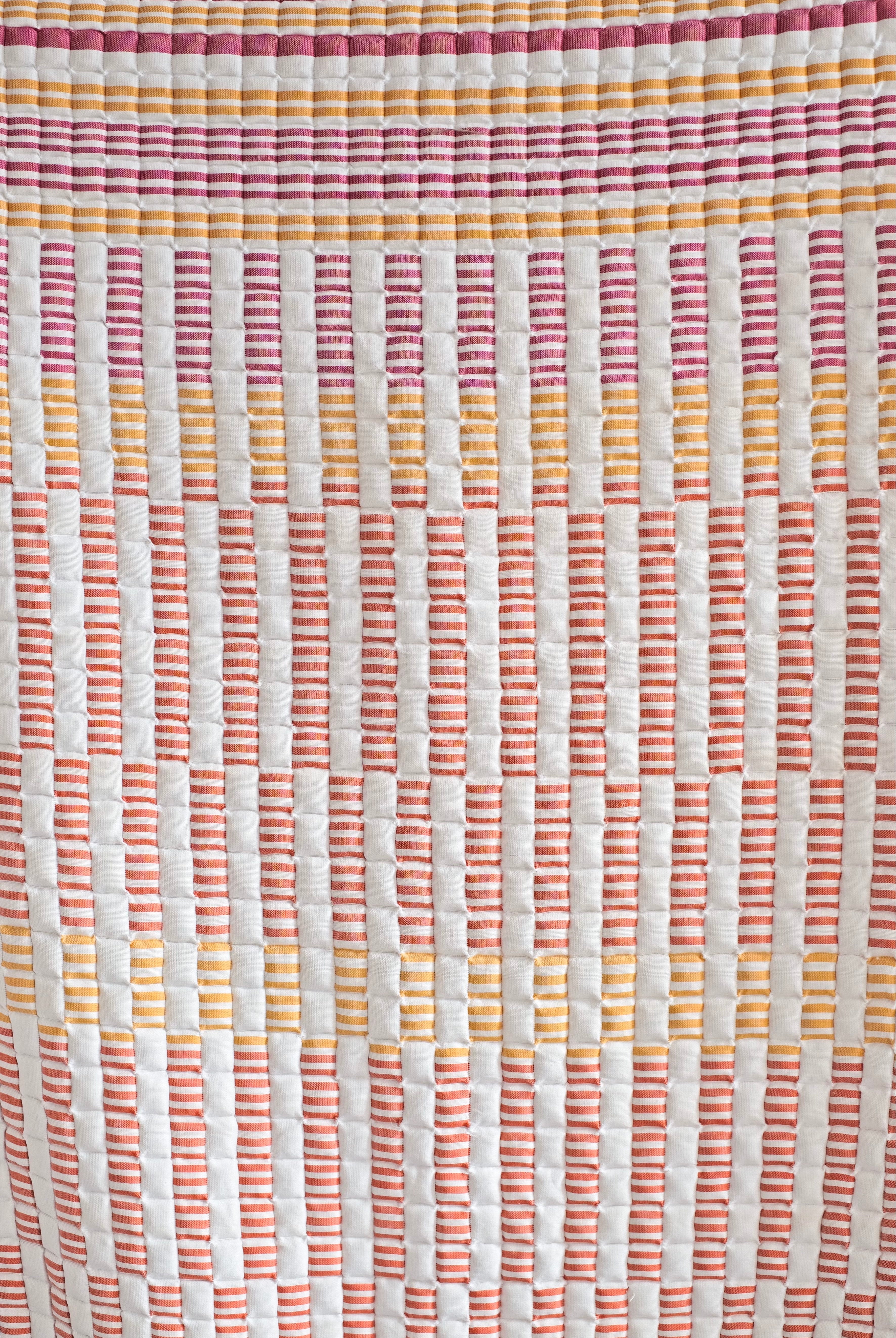 Inner Child sunset sujani quilt close-up showcasing colorful striped pattern