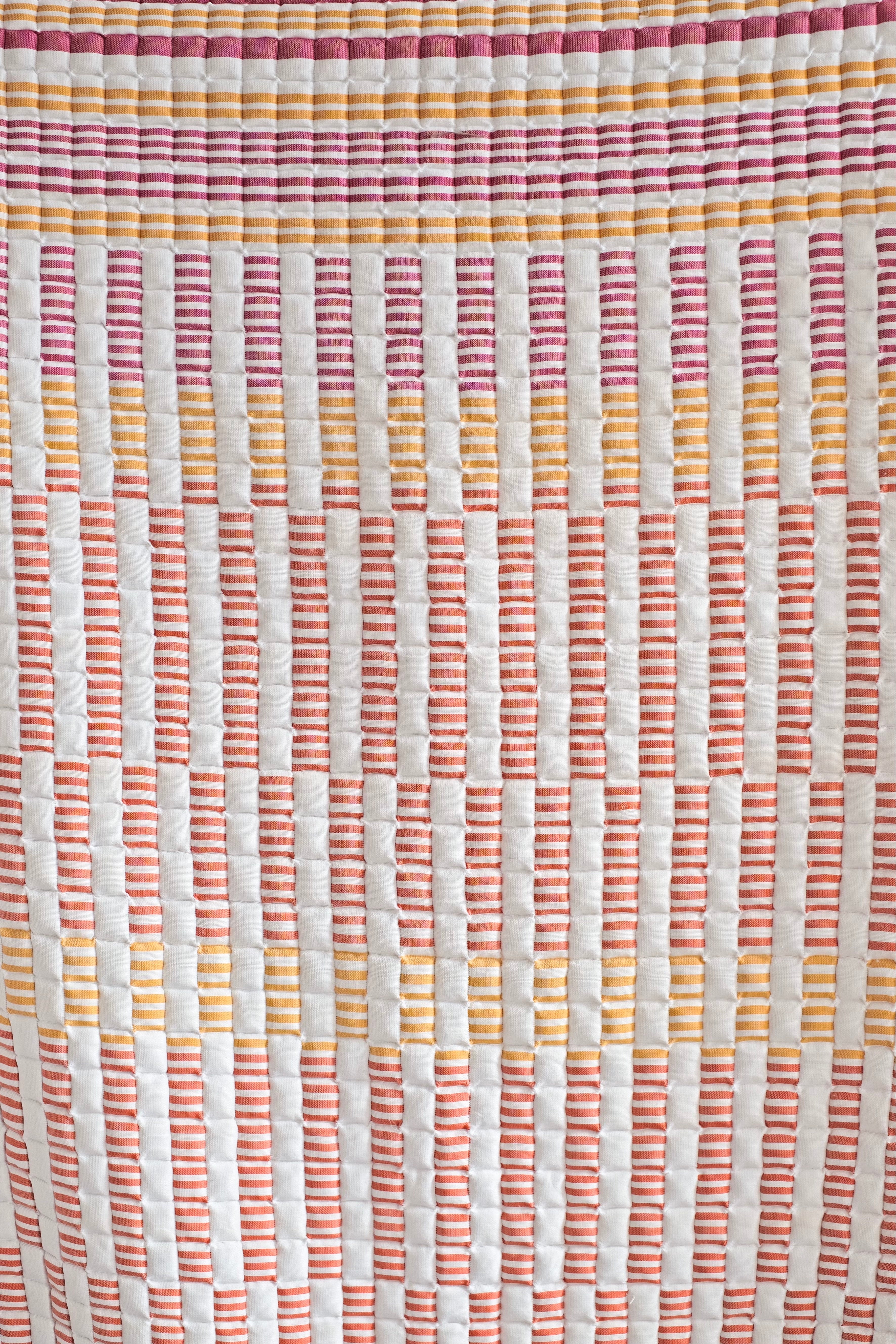 Inner Child sunset sujani quilt close-up showcasing colorful striped pattern