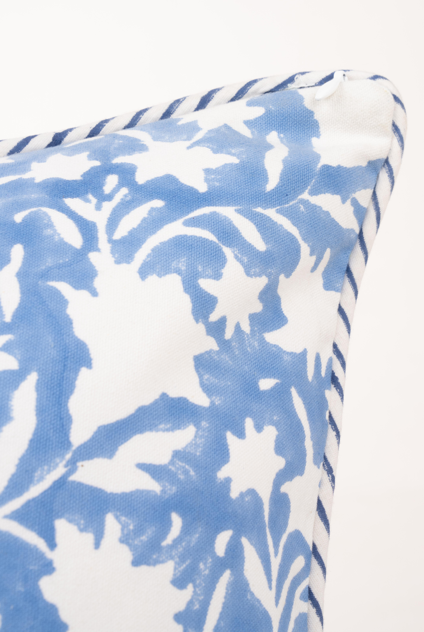Close-up of periwinkle blue pillow showing floral detail