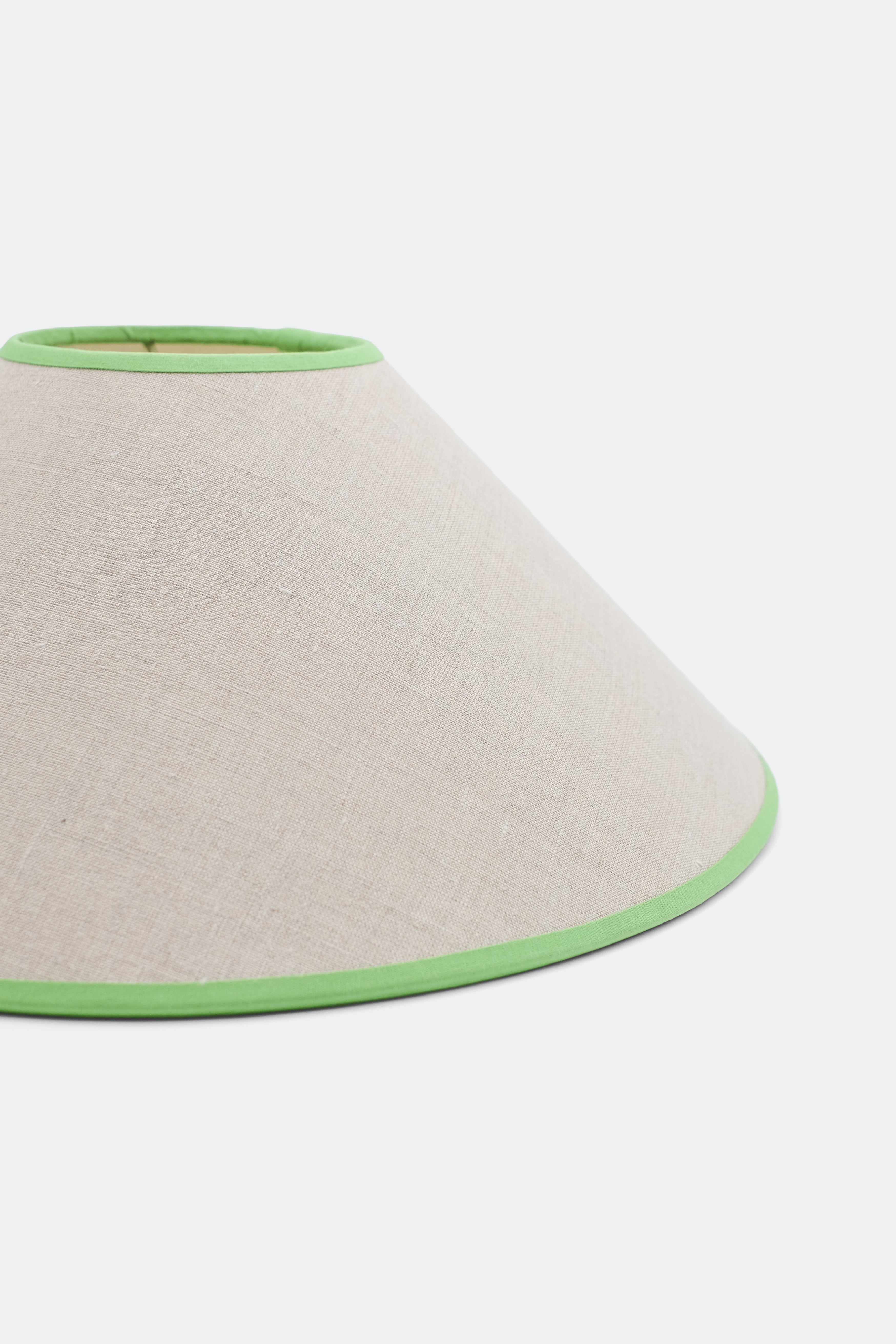 Close-up of 16'' tapered cone lampshade with green trim - linen material
