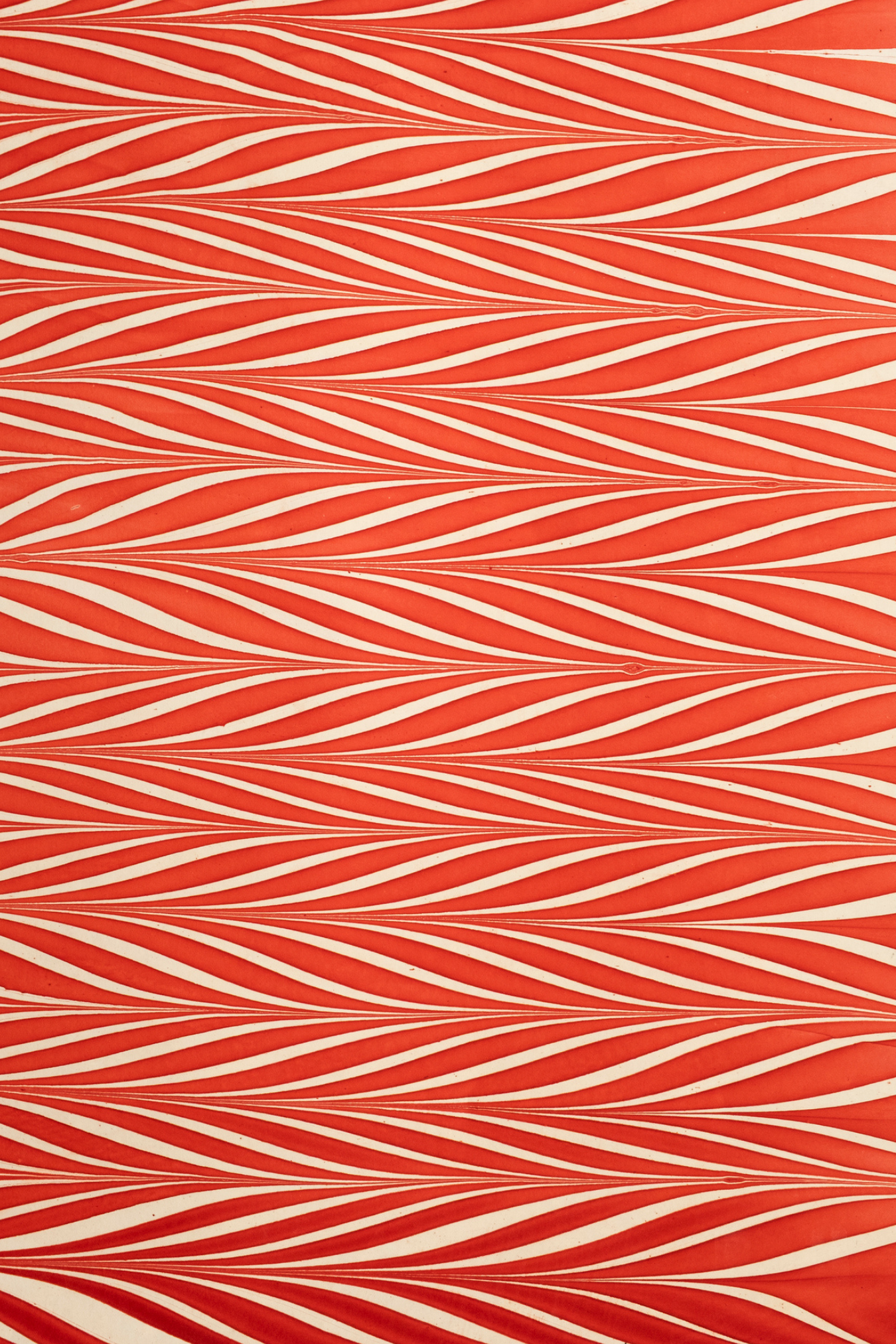 Red and white striped hand marbled candy cane gift wrapping paper sheet close-up