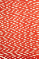 Red and white striped hand marbled candy cane gift wrapping paper sheet close-up