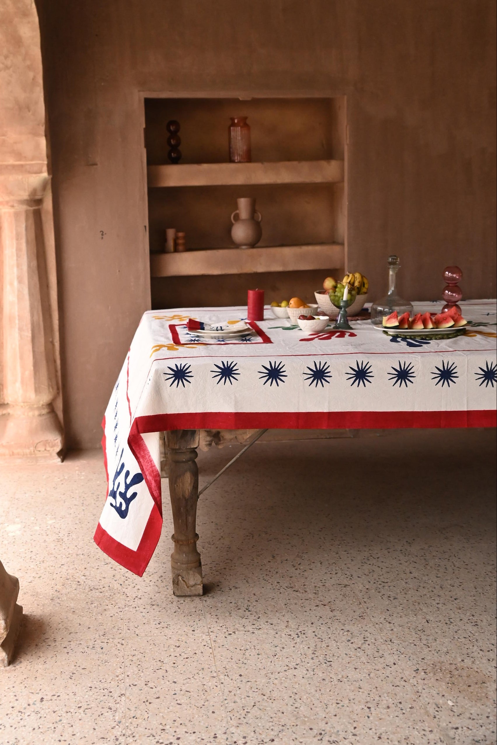 Inner Child Celestial Matisse Blockprint tablecloth on wooden table with fruit display
