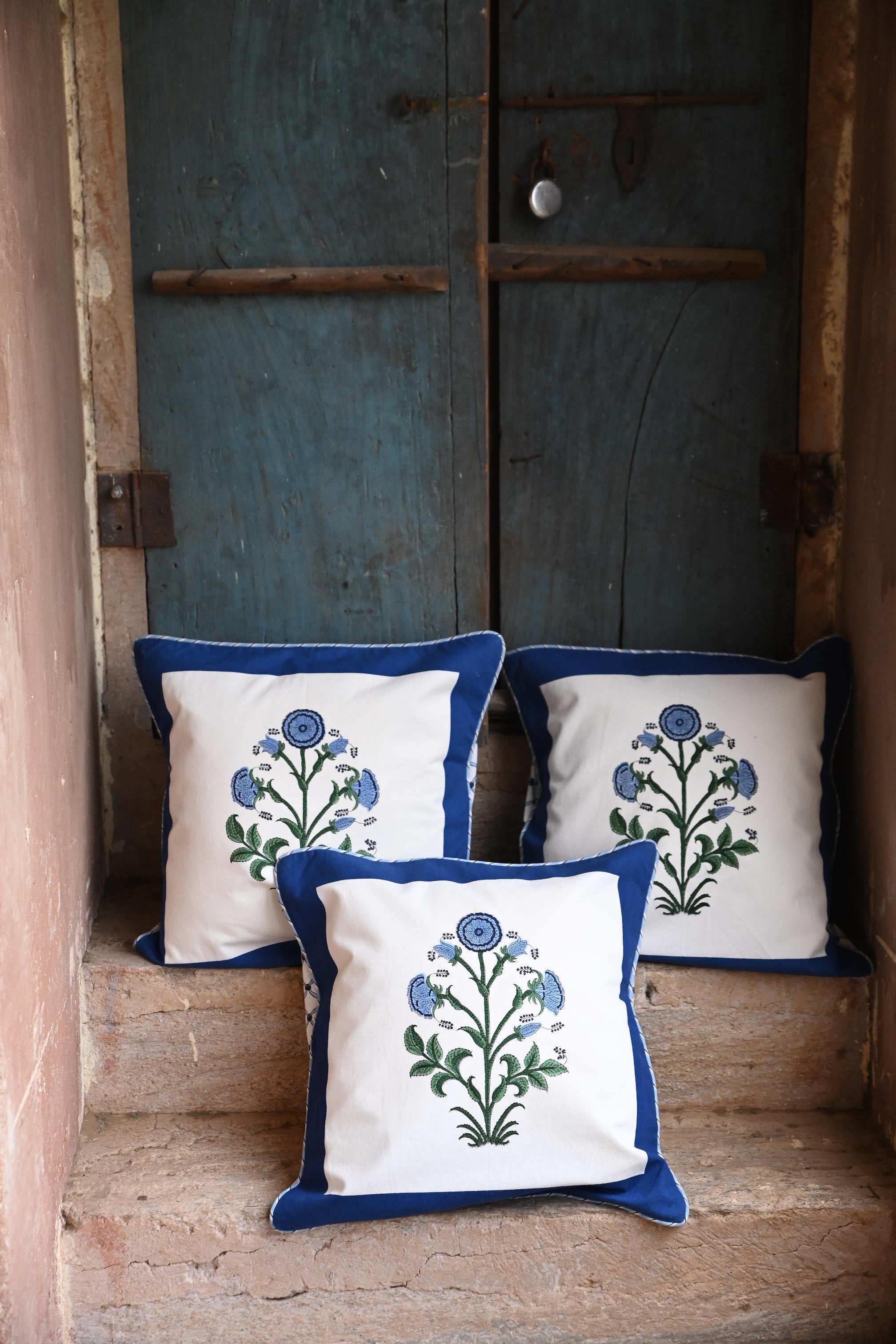 Cobalt botanical blockprint pillows near vintage door