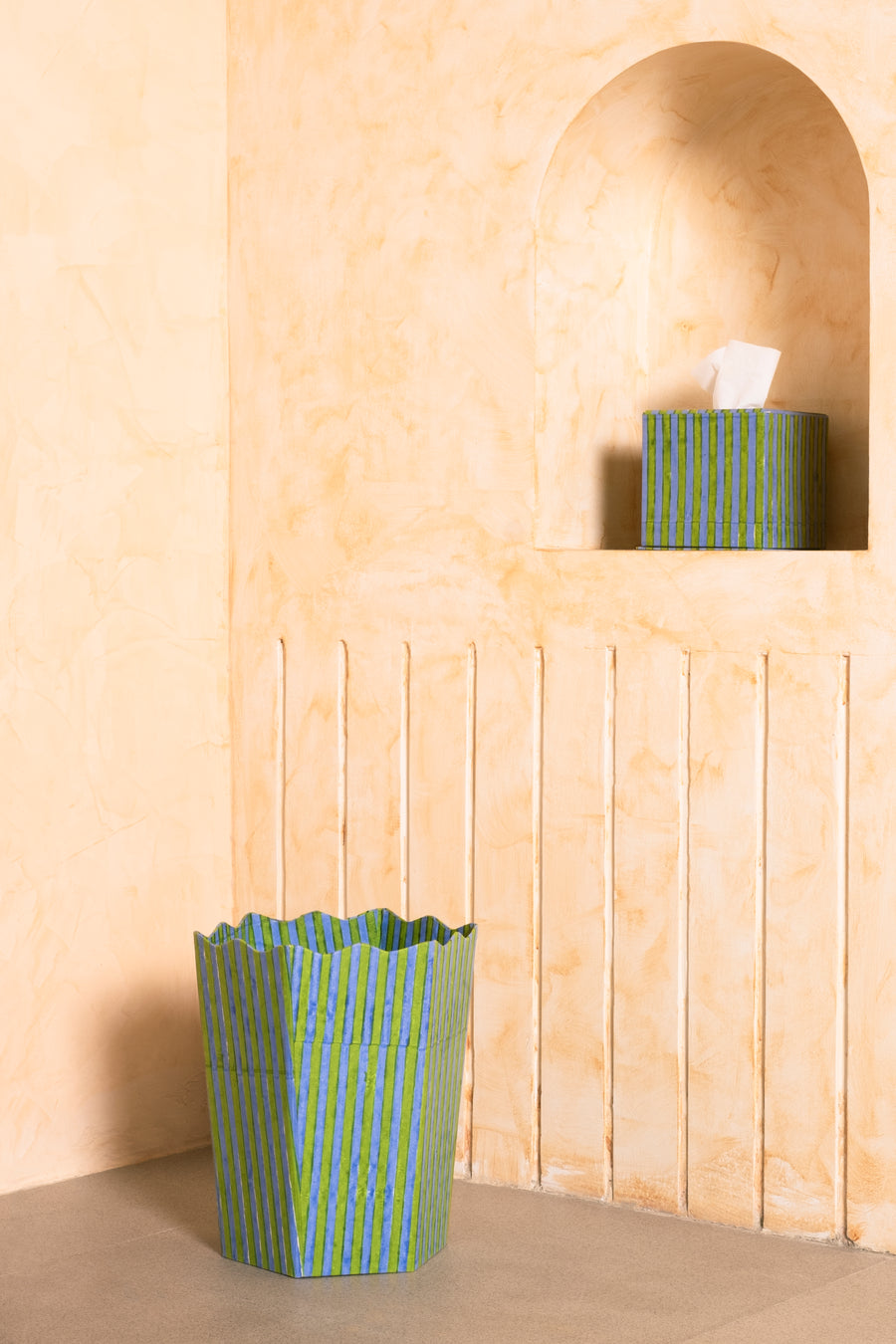 Green and blue striped blockprint tissue box set displayed against warm-toned wall
