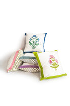 Assorted decorative pillows with blockprint designs and colorful trims