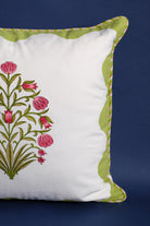 Pink floral blockprint pillow on dark blue background