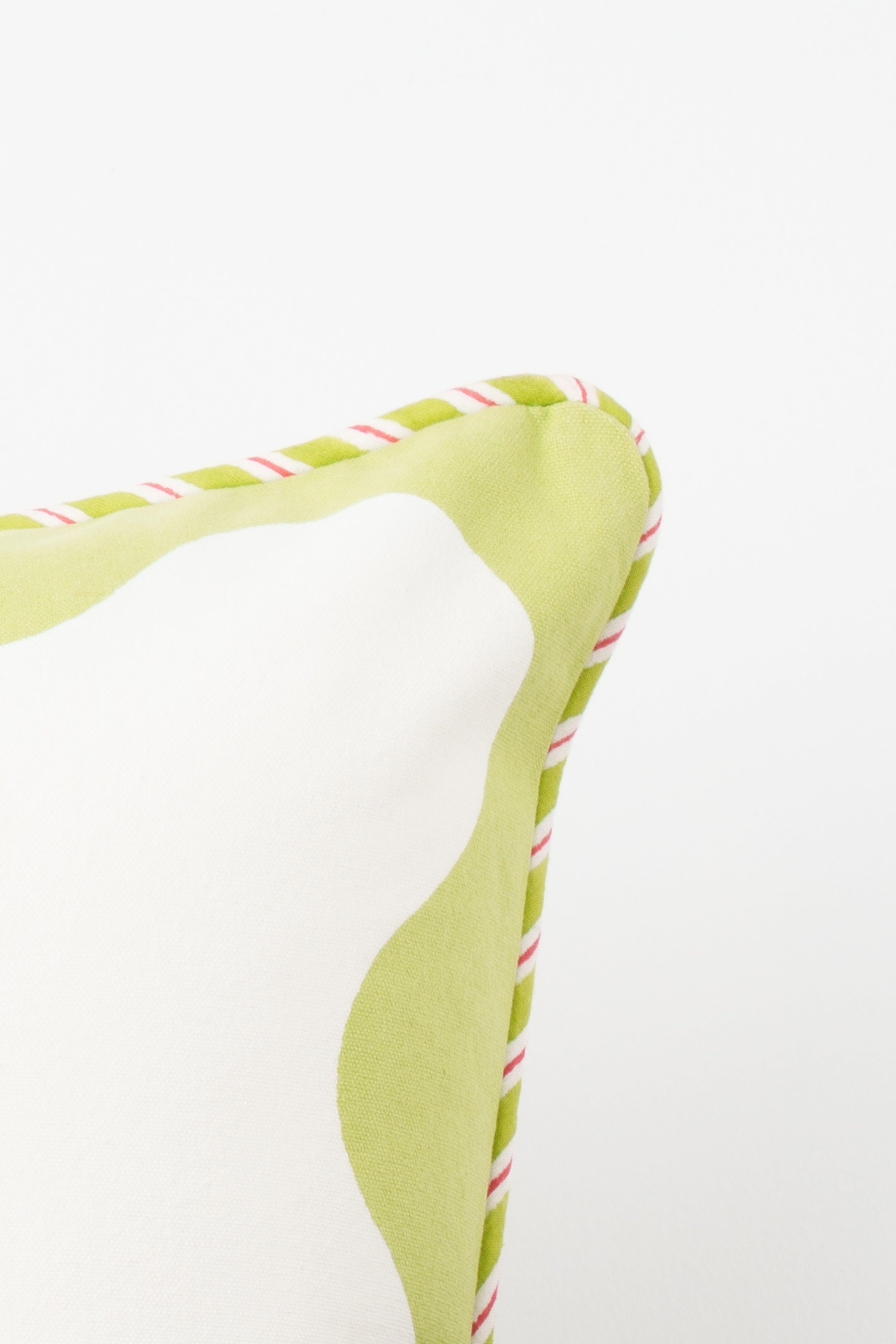 Pillow corner with green trim and striped edge detail