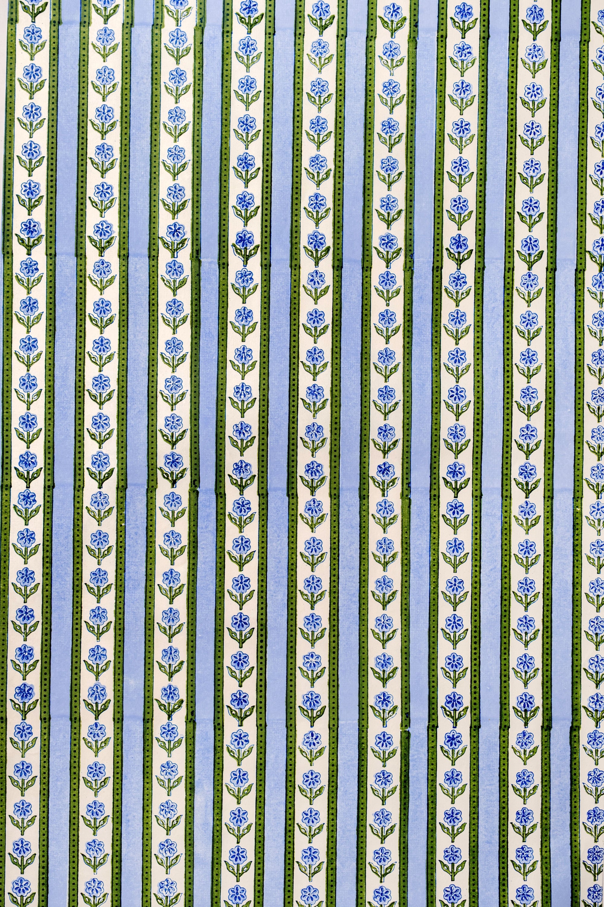 Patterned fabric with blue flowers on a striped background