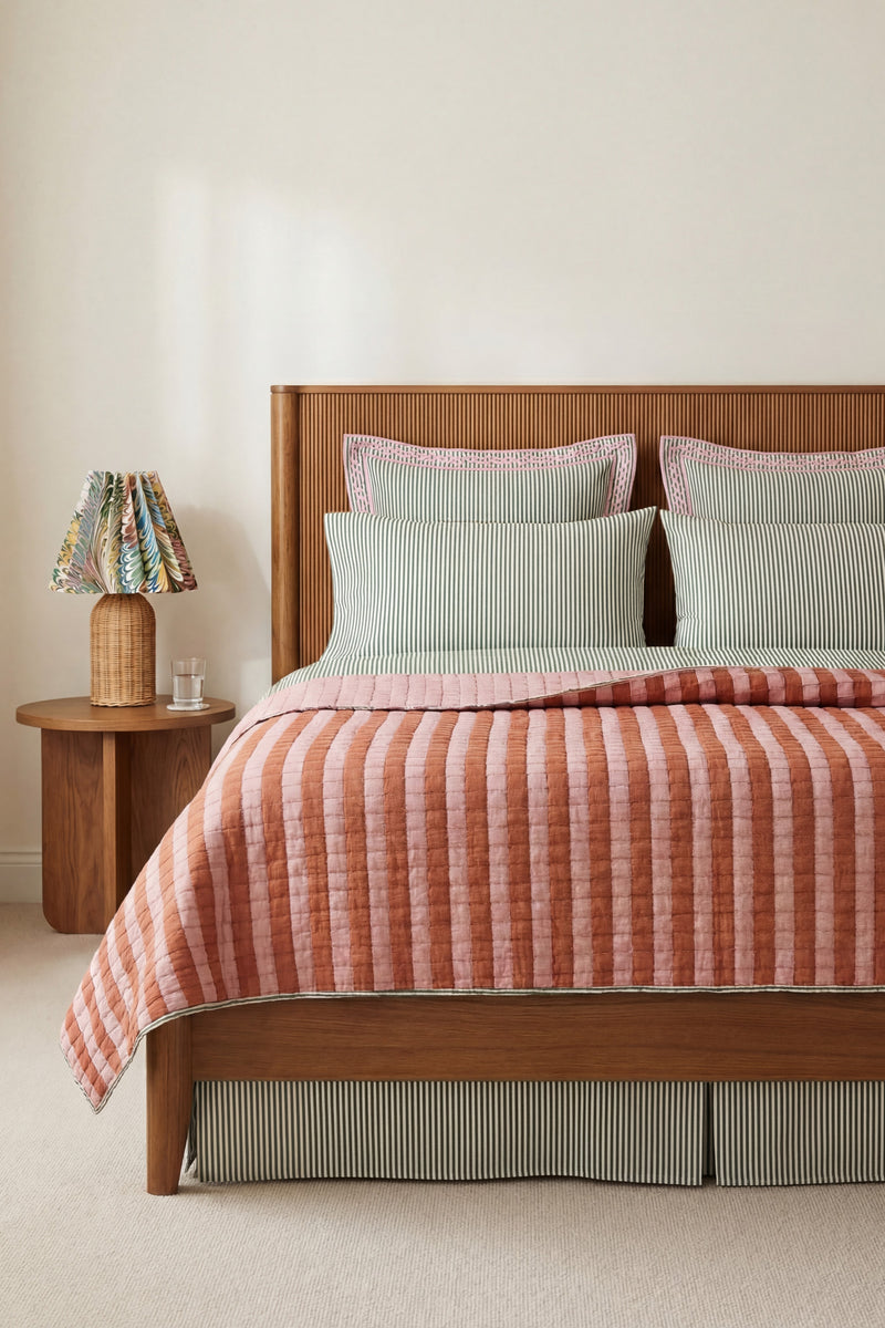 Dusty pink taupe reversible sujani quilt on bed