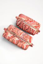 Two florentine pink hand-marbled quilted cosmetic bags with gold zippers