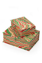 Inner Child hand-marbled keepsake box set in holiday jingle - stacked rectangular boxes with vibrant red, green, and gold marbling patterns