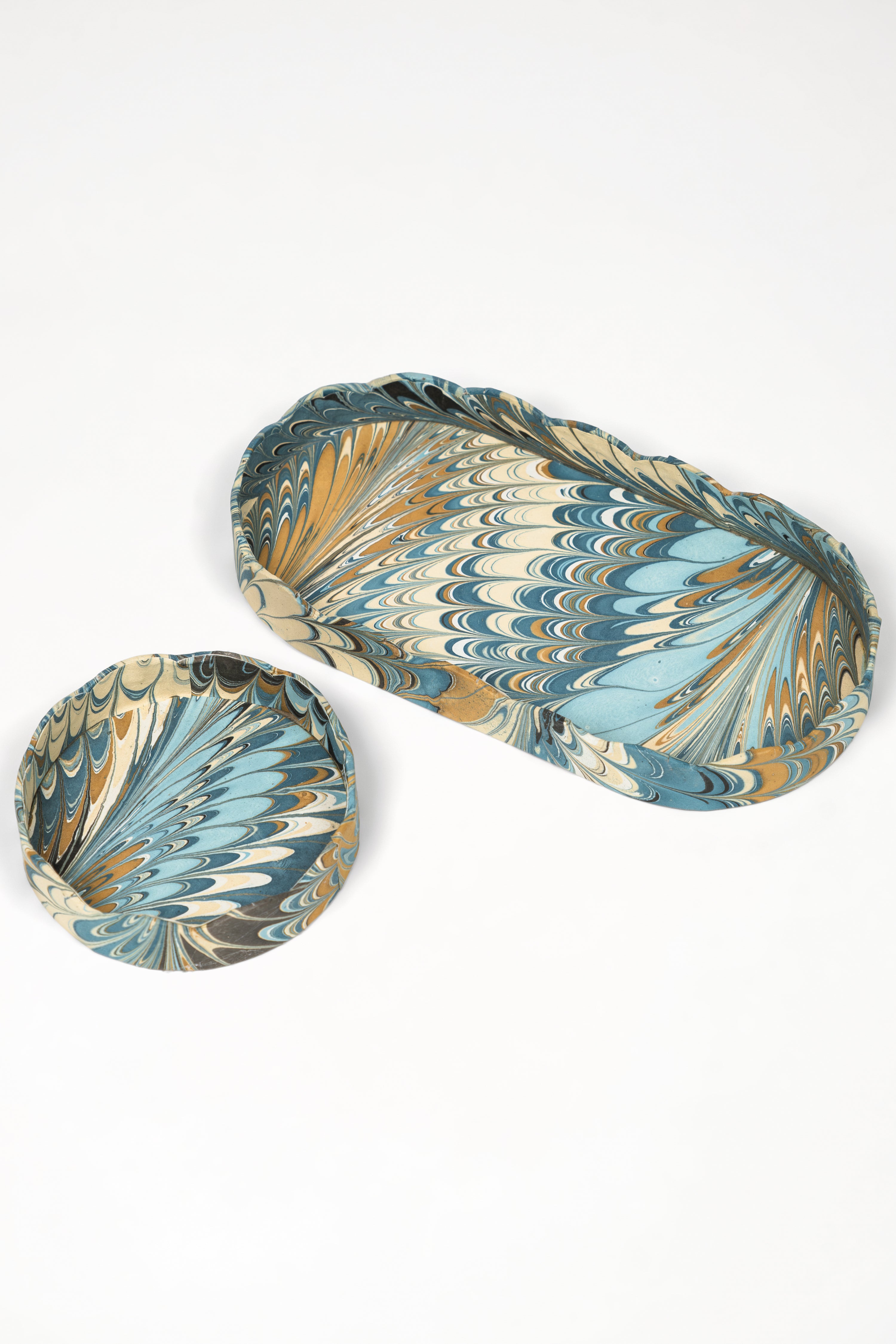 Nesting scalloped hand-marbled oval desk trays with blue and gold marbling