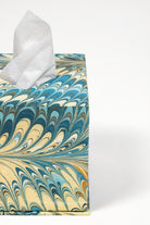 Close-up of hand-marbled tissue box cover showing detailed marbling patterns