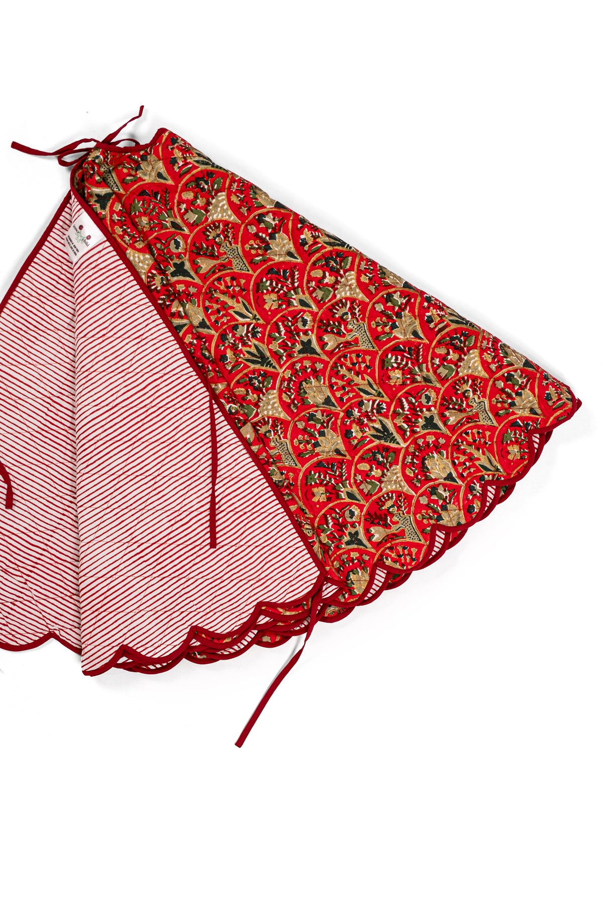 Red Holiday Arch tree skirt folded to show red striped reverse and red ribbon ties